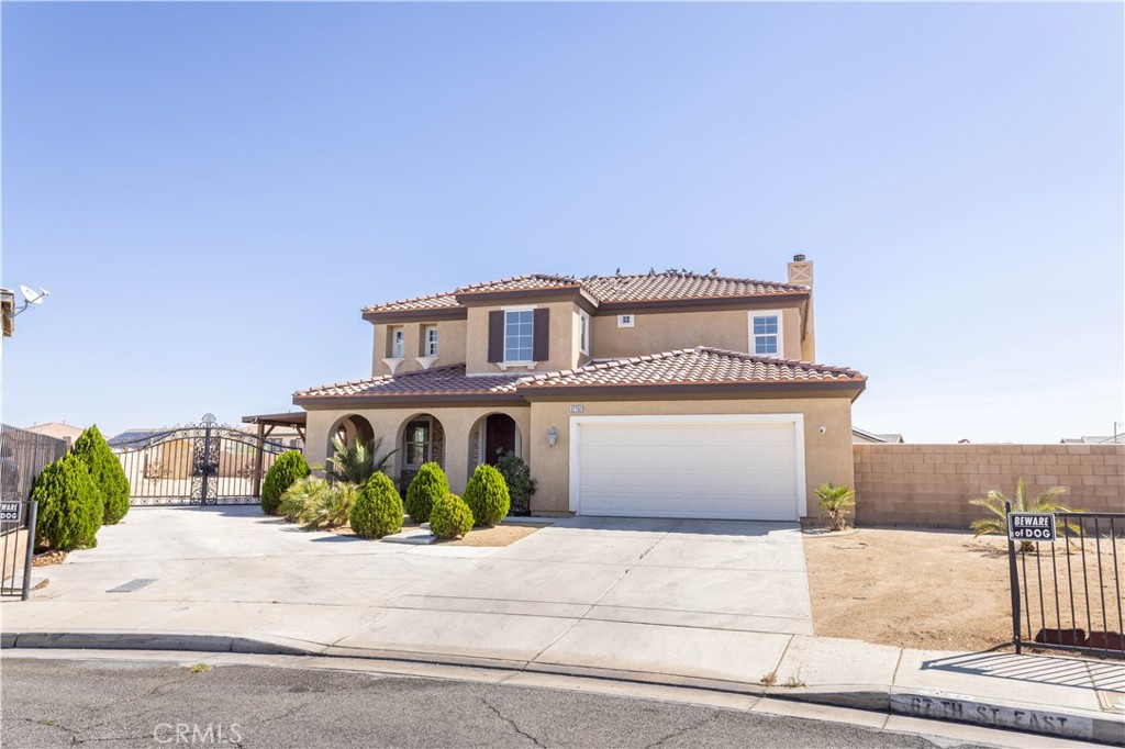 This beautiful home is located in one of East Palmdale's most sought after newer neighborhoods and as soon as you step inside you'll immediately recognize the owner's true "Pride of Ownership". Here are just a few of its many other outstanding features: Groomed shrubbery, portico stacked stone entry, complementary paint scheme and low maintenance tile roof enhance its eye catching curb appeal. You'll step into a flowing 2,250 square foot open concept floor plan that is in "Move In Condition" with recessed lighting, a designer paint scheme and an aesthetic blend of tile and plush carper flooring. The spacious living room is bathed in natural light from a multitude of windows and has a gas burning fireplace, plus media alcove. The family's cook is going to truly appreciate the kitchen's abundant cabinets, ample quartz counters, deep basin stainless steel sink with custom faucet, built in stainless steel appliances, large center island with built in breakfast bar, sit down breakfast area with direct patio access and the convenience of the adjoining formal dining room. 3 bedrooms, the grand suite has a walk in closet with built in organizers and a beautifully appointed bathroom with large dual sink mirrored vanity, soaking tub, and glass enclosed shower. The bonus room could easily be used as a 4th bedroom. A total of 2 1/4 bathrooms. The 1/4 bathroom is located on the first level for your guests. Functionally located laundry room with storage. Energy efficient dual pane windows will help keep your utility bills low and the interior very quiet. Central air & heat. You're going to enjoy the gigantic backyard's open concrete patio and covered side entertainer's patio. You'll have absolutely no problem parking any and all of your vehicles and other toys off street on the gigantic concrete driveway with gated RV access and in the 2 car direct access garage. All this is nestled on a huge 12,398 square foot lot that is close to parks, Madeline Court Recreation Center, restaurants, shopping, and the Walmart Supercenter.