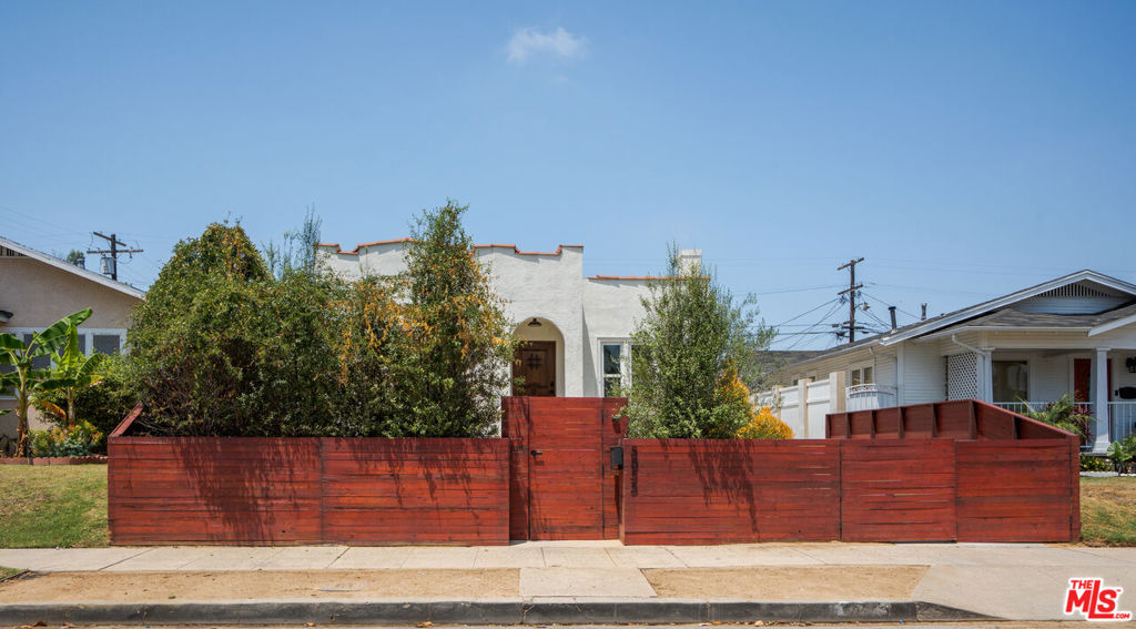 Timeless Charm Meets Modern Living in Hyde Park. Welcome to 5855 Madden Ave, a beautifully restored 1920s Spanish gem located in the heart of Hyde Park. This stunning residence effortlessly blends historic character with modern updates, offering a warm and stylish retreat in one of LA's most vibrant neighborhoods. Classic curb appeal greets you with a Spanish clay tile roof and arched doorway. Inside, laminate wood floors, and a decorative fireplace showcase the home's rich heritage, while abundant natural light fills every corner. The spacious formal dining room leads into a tastefully redesigned kitchen featuring custom cabinetry and stainless steel appliances. The home has been upgraded with new central HVAC, copper plumbing, electrical, and updated roof. Bedrooms are generously sized, and the updated bathrooms offer contemporary finishes with vintage flair. Out back, a detached ADU adds incredible versatility ideal for guests, a home office, creative studio, or rental income potential. The private backyard offers room to relax, entertain, or garden in peace. A gated driveway provides both security and convenience. Set on a quiet street just minutes from the West Adams arts district, Leimert Park, and the Crenshaw Metro line. 5855 Madden Avenue is a rare opportunity to own a thoughtfully restored piece of LA history with all the space and flexibility to grow into the future.
