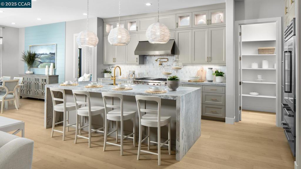 Active Adult 55+ gate community. Welcome to Regency at Tracy Lakes where luxury living takes center stage. With three picturesque lakes, this community offers a fishing dock, 1-acre garden and dog park. A wealth of amenities, including clubhouse, indoor and outdoor pools, cabanas, a yoga studio, fitness center, bocce ball, and pickleball courts, every day here is an opportunity for relaxation and recreation. Onsite lifestyle director ensures there’s always something to look forward to; from fitness classes to comedy shows and wine nights. The well-designed kitchen is enhanced by upgraded JennAir stainless steel appliances, a large center island with breakfast bar, plenty of counter and cabinet space, and a roomy walk-in pantry. The great room is the perfect setting for relaxation with its cozy fireplace and ample natural light. Complementing the primary bedroom suite a large walk-in closet and a primary bath with a dual-sink vanity, a large luxe shower with seat, and linen storage.. Additional highlights include a bonus flex room, a convenient powder room, tankless water heater, modern energy-saving LED integrated recessed lights, and finished 2-car garage. (photos not of actual home or yard for marketing only)