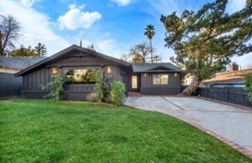 This beautiful tree-lined Woodland Hills gated home is not to be missed! Thoughtfully reimagined by Laura Hawthorn Studios, this 4+3 completely remodeled light-filled home features a long list of upgrades, including BRAND NEW engineered oak hardwood floors that flow throughout the entire home, BRAND NEW roof, BRAND NEW dual paned windows throughout, doors & much more! The inviting living room boasts smoothly finished ceilings, a cozy custom fireplace, and French doors overlooking the entertainer's backyard. The BRAND NEW custom kitchen includes beautiful cabinetry, designer countertops & sleek profession grade stainless-steel appliances, that opens to a large formal dining area bursting with natural light. The primary bedroom offers sanctuary with a hotel-style ensuite bathroom with new vanity, custom tile/fixtures, a luxurious walk-in shower, and a separate relaxing bathtub. The 3rd bedroom / Jr. suite features a remodeled bathroom with stylish tile, new vanity & walk-in stone shower. BRAND NEW plumbing. Additionally, there are 2 other bedrooms that are adjacent to a showstopper redesigned bathroom with free standing soaking bathtub and a new walk-in shower. The many extras include a dedicated laundry room with a built-in pantry, BRAND NEW electrical panel/ wiring & BRAND NEW HVAC system. Enjoy the outdoors within your private backyard featuring a BRAND NEW wood deck, BRAND NEW replastered Pool, and Spa w/ NEW equipment, that is great for entertaining all your family and friends. With the new interior and exterior paint, recessed lighting/designer light fixtures throughout and 2 car attached re-finished garage into a great bonus room/home office. CALL TODAY THIS HOME WILL NOT LAST! CALL ANTHONY | (818) 620-1637