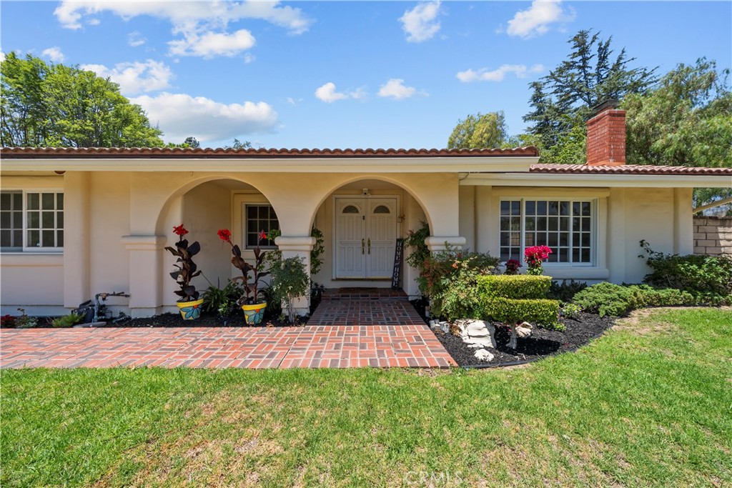 First Time on the Market in 50 Years!
Welcome to this rare and charming single-story gem—a 4-bedroom, 2-bath home filled with warmth, character, and timeless style, nestled on a generous .26-acre lot in one of the most desirable neighborhoods.
From the moment you step through the double front doors, you're greeted by soaring wood-planked ceilings and arched brick accents that immediately set this home apart. Natural light pours in through large windows and sliding glass doors, drawing your eye to the lush backyard oasis.
The open-concept living space flows seamlessly into the warm and inviting kitchen, complete with rich wood cabinetry, vaulted beams, and classic craftsmanship. It’s a space that feels equal parts cozy and expansive—perfect for everyday living and entertaining.
Step outside to your private backyard retreat, featuring a brand new aluminum patio cover, dedicated dining area, lush grassy lawn, and an oversized side yard. It’s absolutely pool-sized and ready for your vision!
The primary suite is a true haven, with vaulted ceilings, an oversized closet, a dressing area, and a freshly remodeled en-suite bathroom. Three additional bedrooms, a second full bath, and a laundry room complete the well-designed layout.
Lovingly maintained by the same family for five decades, this home radiates pride of ownership and timeless charm.
Located near top-rated schools like Beckford, Nobel, and Granada Hills Charter, and minutes from the Vineyards at Porter Ranch and Porter Ranch Park, you’ll enjoy the perfect blend of privacy, community, and convenience.
Don’t miss your chance to own this special piece of Porter Ranch history. Schedule your showing today!