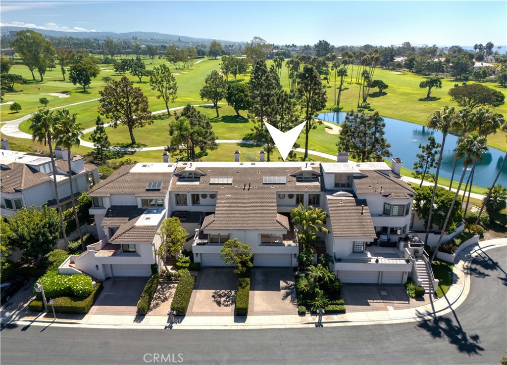 Perfectly positioned on the 17th hole of Newport Beach Country Club, this elegant 2,585-square-foot residence within the 24-hour guard-gated community of Sea Island captures both serenity and striking golf course views. With 2 bedrooms, 2.5 bathrooms, flex room and bar, this home is designed for comfortable living and graceful entertaining. The main living room is anchored by a fireplace and expansive windows that frame golf course views and open to a large private patio, ideal for entertaining or quiet mornings with a view. The adjoining dining area overlooks both the living space and the fairways, while the kitchen enjoys abundant natural light and its own casual dining nook. Upstairs, the primary suite is a private sanctuary, complete with a large walk-in closet and luxurious bathroom featuring dual vanities, a large soaking tub, and separate shower. Step outside to the relaxing deck, providing another vantage point across the rolling greens. The additional bedroom and bathroom offer space for guests and the downstairs flex room offers versatility for a home office, media space and more. As part of Sea Island, you’ll enjoy resort-style amenities including two pools and spas, two tennis courts, a clubhouse, all just steps away. Beyond the gates, take in the best parts of Newport Beach, Fashion Island, Balboa Island, Back Bay, fine dining, shopping, and convenient freeway access are all nearby. 20 Ocean Vista offers not just a home, but a refined coastal lifestyle at the heart of Newport Beach.