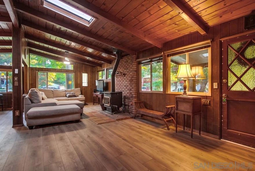 Charming home on a quiet street in the heart of Julian. This private, tucked away retreat offers a chance to enjoy all that life in the mountains has to offer. The home rests on just under 1/4 of an acre, and boasts 2 spacious bedrooms, a large living area that opens to the kitchen, and a dining space overlooking the beautiful outdoors. The custom windows throughout bring in tons of natural light and the vaulted ceilings create a sense of openness, while preserving the cozy-cabin feel. The home is perfect for a small family, or could be used as a vacation home getaway and the detached 2-car garage offers space for storage and parking. Pride of ownership abounds with updated flooring, fresh exterior paint, and dual pane windows. The front patio is the perfect spot to enjoy a morning cup of coffee or an evening outside watching the sunset. Hurry, this one won't last long!  Kentwood in the Pines is only 5 minutes from downtown Julian, which is known for its historic charm, apple orchards, and stunning mountain scenery. Julian offers a peaceful retreat just an hour from the hustle and bustle of San Diego.