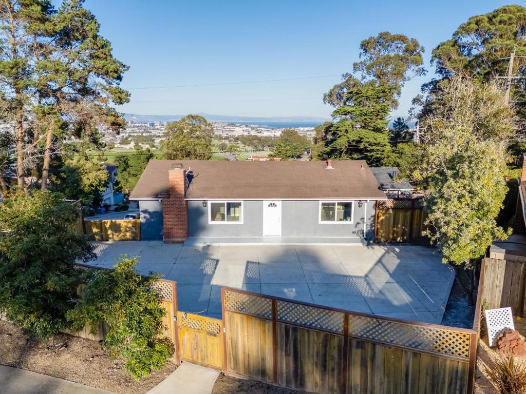 Situated on an oversized corner lot in the desirable Rollingwood neighborhood, this beautifully updated home offers the perfect blend of space, style, & versatility. The expansive front yard sets the tone, showcasing spectacular panoramic views & incredible curb appeal. Inside, thoughtful design & modern updates/remodeling create a warm atmosphere. The open-concept kitchen & living room area flow seamlessly together, ideal for both hosting & everyday living. The updated kitchen features high-end appliances, a dining area, & sleek finishes. Upstairs, you'll also find 3 comfortable bedrooms & 2 pristine bathrooms, including a luxurious primary suite w/ its own private bath. Other highlights include recessed lighting, storage cabinets, large windows, a remodeled garage, & tasteful flooring. The newer lower level offers exceptional flexibility, serving as a separate living quarter complete with its own updated full kitchen, bedroom, bathroom, & private entrance, perfect for multi-generational living or potential rental income. Enjoy a spacious backyard plus convenient access to Highway 280 for an easy commute between Silicon Valley & San Francisco. Families will appreciate proximity to top-rated schools, as well as downtown San Bruno's popular shops & restaurants just minutes away.