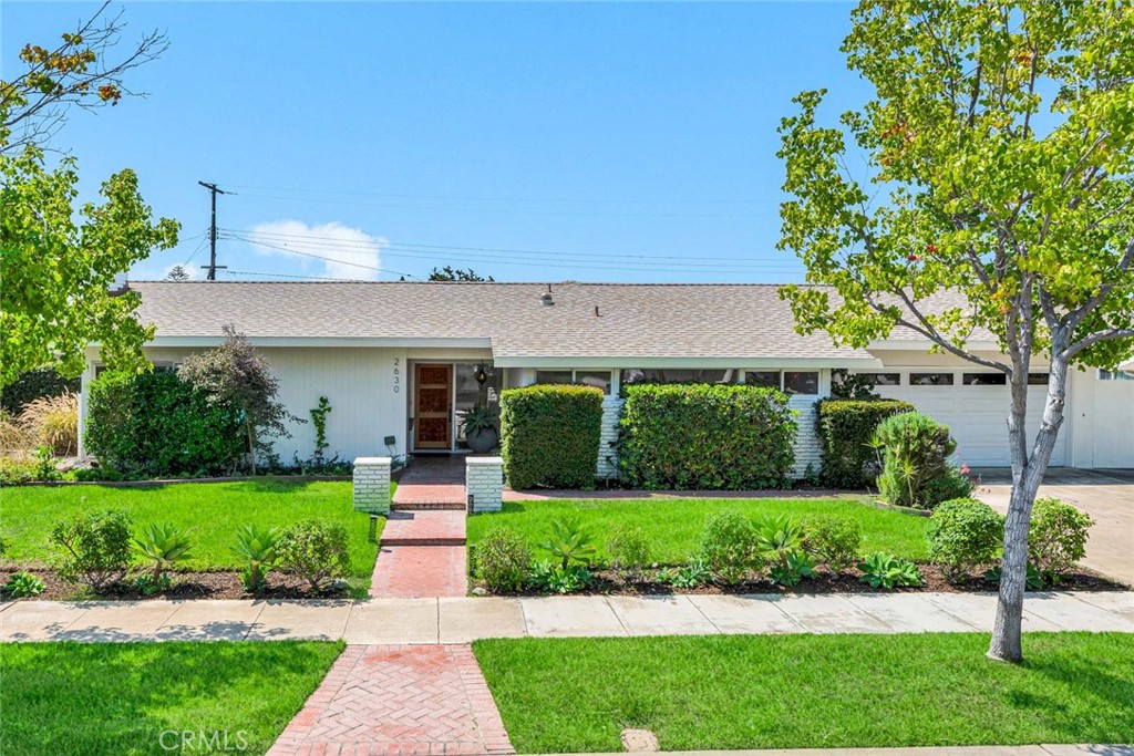 Welcome to 2630 E. Larkstone Drive, a Single Level Mid-Century Modern Home on a Tree Lined Street in the Heart of Orange. This Turn-Key Dream Home Features Four Bedrooms, Two Bathrooms, Hardwood Floors Throughout, Vaulted Ceilings, and Large Picture Windows Providing an Abundance of Natural Light Throughout. Additional Owner Upgrades Include a New Roof, New Insulation, New Pool Pump, Remodeled Bathrooms, Newer Water Heater, Newer Electrical Panel, Newer Interior/Exterior Paint, Water Softener, Custom Front Door, and More! The Living Room Enjoys a Vaulted Ceiling, Cozy Fireplace, and Overlooks the Backyard. The Upgraded Kitchen Enjoys Quartz Counters, Stainless Steel Appliances, Floating Shelves, Peninsula with Seating, and Opens to the Dining Room with Backyard Access Which is Perfect for Entertaining. The Spacious Master Suite Enjoys Plenty of Closet Space and a Remodeled Bathroom with Skylight and Frameless Glass Walk-In Shower. The Expansive Backyard Includes a Large Pool, Covered Patio, Grass Area, Lush Landscaping, and Multiple Seating Areas. Indoor Laundry Room and Two Car Garage with Built-In Cabinets. Minutes to Shopping, Dining, Entertainment, Parks, and Old Towne Orange (Plaza). Easy Access to the 55/22/91 Freeways and 241/261 Toll Roads. No HOA or Mello-Roos. 2630 E. Larkstone Drive is a Must See!