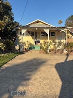 Step back in time to own a charming 1926 Ziegler bungalow on 10,000+ square ft. lot. Home features 2 bedrooms, 1 bathroom, and classic architectural details such as original hardwood floors, mahogany woodwork, and vintage hardware. The inviting front porch provides entry into a living room with the original tile fireplace. Behind the kitchen you will find an enclosed sunroom with washer and dryer hookups and basement access. The entire exterior is freshly painted. Enjoy an oversized backyard with mature avocado and citrus trees and 2 large patios. One area includes a free standing barbecue with stamped concrete, great for entertaining. A large gate in the back offers RV access and a storage shed is also included! This property is located in a desirable neighborhood and offers a perfect mix of history, style and comfort. It's close to great schools, parks, Anaheim Packing District, Center St. Promenade and Disneyland. There is lots of potential for this beautiful historical property, centrally located in the heart of Anaheim, including possible Mills Act qualification and ADU development.