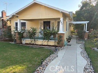 Step back in time to own a charming 1926 Ziegler bungalow on 10,000+ square ft. lot. Home features 2 bedrooms, 1 bathroom, and classic architectural details such as original hardwood floors, mahogany woodwork, and vintage hardware. The inviting front porch provides entry into a living room with the original tile fireplace. Behind the kitchen you will find an enclosed sunroom with washer and dryer hookups and basement access. The entire exterior is freshly painted. Enjoy an oversized backyard with mature avocado and citrus trees and 2 large patios. One area includes a free standing barbecue with stamped concrete, great for entertaining. A large gate in the back offers RV access and a storage shed is also included! This property is located in a desirable neighborhood and offers a perfect mix of history, style and comfort. It's close to great schools, parks, Anaheim Packing District, Center St. Promenade and Disneyland. There is lots of potential for this beautiful historical property, centrally located in the heart of Anaheim, including possible Mills Act qualification and ADU development.