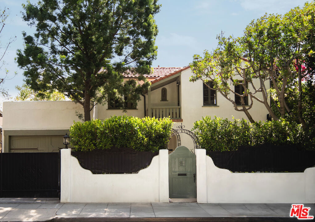 Elegant design, luxurious finishes, and sweeping views define this 1926 Spanish Colonial in one of Los Feliz's most sought-after enclaves. The home has been meticulously designed, and all systems have been upgraded over the past two years. Upon entering, you are greeted by a living room that exudes warmth and grandeur with arched windows, coved ceilings, Italian Murano sconces, and a classic fireplace. A chef's kitchen with Wolf appliances, stone counters, and Waterworks fixtures flows into a window-lined dining room overlooking the backyard and skyline. With five bedrooms and four bathrooms, the home offers abundant space and flexibility. Each upstairs suite includes an en suite bath and opens to private sunlit decks with Zia marble tile and views of the Griffith Observatory and surrounding hills. The lower level offers a screening room, den, two guest suites and a cedar sauna. The extraordinary outdoor living spaces were crafted by AD100 landscape designers Terremoto, featuring native plantings, gardens, fruit trees, redwood decking, cedar jacuzzi, and custom fencing. Located just moments from local favorites on Vermont and Hillhurst and steps from the scenic trails of Griffith Park. This timeless turnkey Los Feliz home is a rare blend of architectural heritage and modern luxury.
