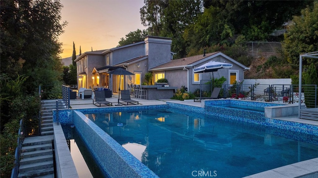 Experience luxury living in this completely renovated, over 4,800 sq ft estate, offering 8 bedrooms and 7 bathrooms of sleek, contemporary design. Behind private gates, this exclusive oasis blends sophisticated style with ultimate comfort. The open-concept layout features soaring ceilings, expansive windows, and high-end finishes throughout. The gourmet chef’s kitchen boasts custom cabinetry, premium appliances, and a spacious island perfect for entertaining. Multiple living and dining areas flow seamlessly to the outdoors, where lush landscaping creates a serene, resort-like atmosphere. The furnished lease includes designer pieces that complement the home’s modern aesthetic. Bedrooms are generously sized, with luxurious en-suite bathrooms and abundant natural light. The primary suite offers a spa-inspired bath and private balcony. Enjoy exceptional privacy while still being conveniently close to shops, dining, and top-rated schools. Perfect for those seeking an upscale, turn-key residence.