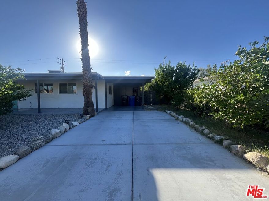 ***MOTIVATED SELLER*** This charming Mid-Century Solar home features  3 bedrooms and 1 bath, with dual pane windows.  The heart of the home is a wide-open kitchen, equipped with stainless steel appliances and a breakfast bar, seamlessly flowing into the living room. From the dining room, sliding doors lead out to a spacious covered patio with a fire pit, surrounded by a private, lush yard and beautiful hedges. There's plenty of room in the backyard for a pool and or ADU. The property also boasts several orange and lemon trees, offering stunning views of the surrounding mountains and desert, and a separate laundry room with its own entrance. Ideally located, this home is just minutes from Palm Springs International Airport as well as nearby shopping, dining, and schools.  This is a move-in-ready gem- you won't want to miss!