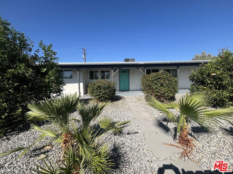 This charming Mid-Century Solar home features 3 bedrooms and 1 bath. The heart of the home is a wide-open kitchen, equipped with stainless steel appliances and a breakfast bar, seamlessly flowing into the living room. From the dining room, sliding doors lead out to a spacious covered patio with a fire pit, surrounded by a private lush yard and beautiful hedges. There's plenty of room in the backyard for a pool and or ADU. The property also boasts several orange and lemon trees, with stunning mountain and desert views. Separate laundry room with its own entrance. Ideally located, this home is just minutes from Palm Springs International Airport as well as nearby shopping, dining, and schools. This is a move-in-ready gem- you won't want to miss!