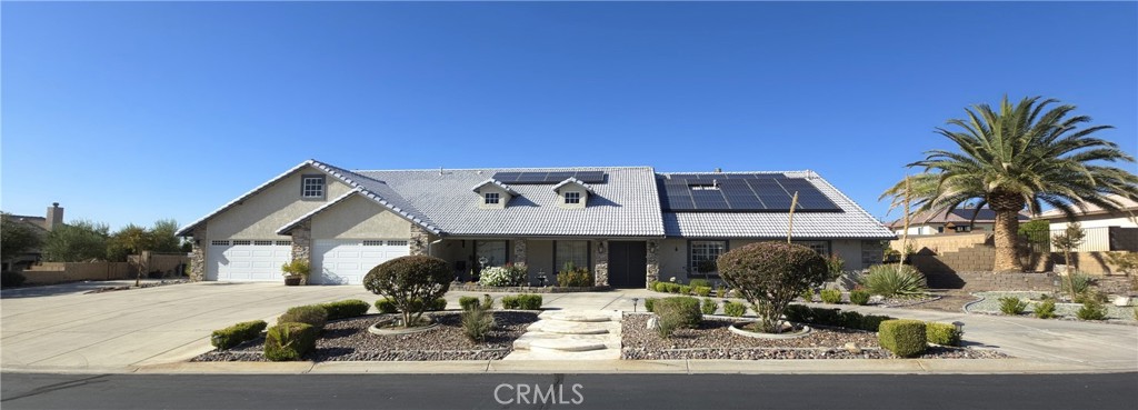 Imagine settling into this enchanting custom home in the peaceful, gated Quail Valley Estates, ideally centered in Apple Valley for easy access to all your favorites. As fall's gentle hues unfold, this gem invites cozy evenings by the fire pit under twinkling stars or serene mornings in sun-drenched spaces. The backyard haven features a solar-heated pool with pebble-smooth bottom, relaxing Jacuzzi, twin waterfalls, fun slide, and wide deck with umbrella spots for breezy lounging. Nearby, the covered outdoor kitchen shines with granite counters, sink, fridge, serving bar, and gas grill—ideal for autumn gatherings or harvest feasts with loved ones. The landscape enchants with broad concrete patios, a inviting fire pit, fruit trees heavy with seasonal bounty, expert landscaping, ample shed space, and RV parking for quick escapes. Grand double doors with security screens lead to expansive formal living and dining rooms, perfect for heartfelt meals or lively get-togethers. At the core, the family room warms with its fireplace and kitchen views—a culinary delight boasting a sunny nook of custom cabinets, high-end appliances, roomy pantry, granite island, and French doors merging indoors with the yard's calm. Seven spacious bedrooms and five full baths await, including a practical Jack-and-Jill. The master suite offers pure serenity: generous proportions, private fireplace, flexible retreat with exterior access (envision a quiet study, guest nook, or poolside sanctuary with full bath), five shaded French doors to the outdoors, and a subtle pet door. Timeless wood shutters on all windows add elegance and soft seclusion. Powered entirely by PAID OFF SOLAR, More than a house, this is a backdrop for life's warmest moments—from fall's colorful vistas to holiday glow.