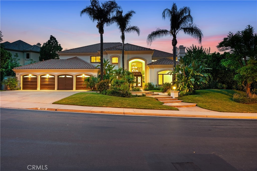 Tucked within the prestigious gates of Mountainview Estates in Calabasas, this exquisite Mediterranean residence blends timeless elegance with contemporary sophistication. A lush, tropical front garden creates a striking first impression, leading to grand wrought iron double doors that open into a home defined by scale, light and luxury. Soaring volume ceilings introduce the expansive interior, while wide plank white oak flooring infuse the space with warmth and modern character. The formal living room makes a bold statement with its floor to ceiling dark grey venetian plaster fireplace and intricate coffered ceilings. French doors off of the expansive family room open to a serene zen garden enclosed by mature bamboo for ultimate privacy and a peaceful retreat perfect for quiet reflection or meditation. The updated kitchen is bright and refined, outfitted with quartz countertops, stainless steel and chrome finishes, a central island with bar seating and an informal dining nook perfect for casual meals. The luxurious primary suite is a tranquil escape with rich blonde floors,cozy fireplace and a seperate sitting area.The spa inspired primary bath includes dual vanaties, soaking tub, an oversized walk in shower and private water closet. Step outside to discover a true backyard oasis. Large covered patio, built in fireplace, skylights and BBQ island sets the stage for year round outdoor living. The lagoon style pool and spa with cascading waterfalls has lush, tropical landscaping offering both privacy and serenity. This home is the epitome of California Luxury, designed with style, luxury and functionality in mind.