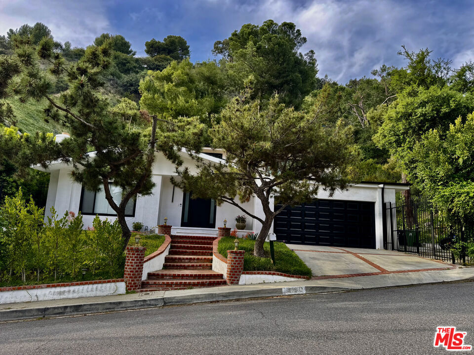 Welcome to 9781 Blantyre Drive a beautifully remodeled 3-bedroom, 3-bathroom home nestled in a serene Beverly Hills cul-de-sac. This 2,135 sq ft residence, set on a generous 0.66-acre lot, combines mid-century charm with modern updates, offering a tranquil retreat in the prestigious Beverly Crest neighborhood. Inside, the home features a spacious layout with updated interiors, including hardwood flooring and a contemporary kitchen equipped with modern appliances. The living areas are designed for comfort and style, providing ample space for relaxation and entertainment. The expansive backyard is a standout feature, boasting a well-maintained retaining wall and ample space for outdoor activities or future landscaping projects. Situated in a quiet cul-de-sac, the property ensures privacy and minimal traffic, enhancing the peaceful living experience. Located within the Los Angeles Unified School District, residents have access to quality education options. The home's proximity to city amenities, coupled with its secluded setting, offers the best of both worlds.