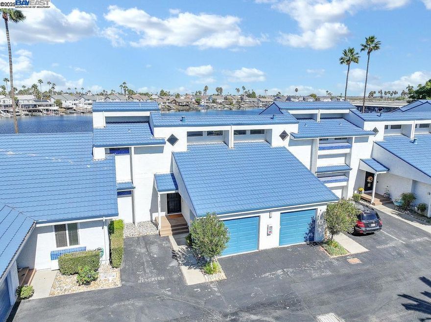 HARBOR BAY CONDO W/FABULOUS WATER VIEWS! RESORT STYLE LIVING OR PERFECT SECOND HOME - COMPLETELY RENOVATED WITH DESIGNER TOUCHES THROUGHOUT - THIS BEAUTIFUL UNIT OFFERS 1354 SQ FT WITH 2 BEDROOMS (ONE BED/BATH ON MAIN LEVEL), 2 FULL BATHS + BONUS LOFT (POSSIBLE CONVERSION TO 3RD BEDROOM) - Open concept living with water views from every room - Spacious living area w/high vaulted ceiling, luxury planked flooring, fireplace w/accent tile, dining area and slider door to spacious deck - Kitchen w/quartz counters, SS appliances + refrigerator, eat at bar & stack washer & dryer included - Both baths updated w/quartz counters, stall showers and tile flooring - Upper level offers Primary Suite w/high vaulted ceiling and balcony + Bonus Loft - Single car garage w/epoxy floor + assigned parking space in front of Unit - Walk along the waterfront path to the Marina, Yacht Club, Marina Bar & Grill or walk, jog, bike ride on levy for miles - Across the street you will find Discovery Bay Country Club for any golf enthusiast - Community Pool + Close by Community Center w/lap pool, Pickle Ball & Tennis - Live Where You Play - Many Discovery Bay Community activities throughout the year - All this and more...