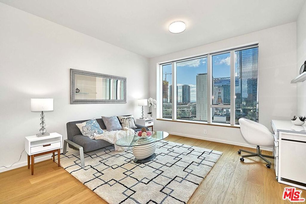 SELLER MOTIVATED!! UPGRADED LIGHT FIXTURES!! ** FULLY FURNISHED!! ** Luxury Condo in Prestigious DTLA Metropolis Tower 1. OPEN SOUTH VIEW, this exceptional 1-bedroom, 1.5-bathroom residence offers unparalleled, sweeping views of the Los Angeles skyline from every direction. The meticulously designed interiors feature an open-concept layout complemented by high-end finishes, including Caesarstone countertops, sleek custom cabinetry, and premium Bosch appliances. Elegant oak wood flooring flows throughout, adding warmth and sophistication, while floor-to-ceiling windows bathe the unit in natural light and showcase the stunning city vistas. Enjoy the convenience of in-unit laundry facilities and custom window shades, providing privacy and comfort. This luxurious high-rise offers residents exclusive access to world-class amenities: relax in the resort-style pool and spa, stay fit in the fully-equipped gym, or unwind in the private lounges and cinema. Additionally, stylishly appointed community spaces make socializing and working from home more convenient, fun, and productive. Experience elevated urban living at its finest in one of DTLA s most prestigious addresses. Stunning condo offering breathtaking views of Downtown LA, Griffith Observatory, and the Hollywood Sign. Located in the heart of the Financial District, steps away from Koreatown and Little Tokyo, and Crypto Arena. Enjoy 24-hour security, front lobby service, and included WIFI. Amenities feature a sparkling pool, gym, steam room, and Jacuzzi, ensuring luxurious urban living at its finest. Additional parking available for purchase in the monthly parking garage across the street.
