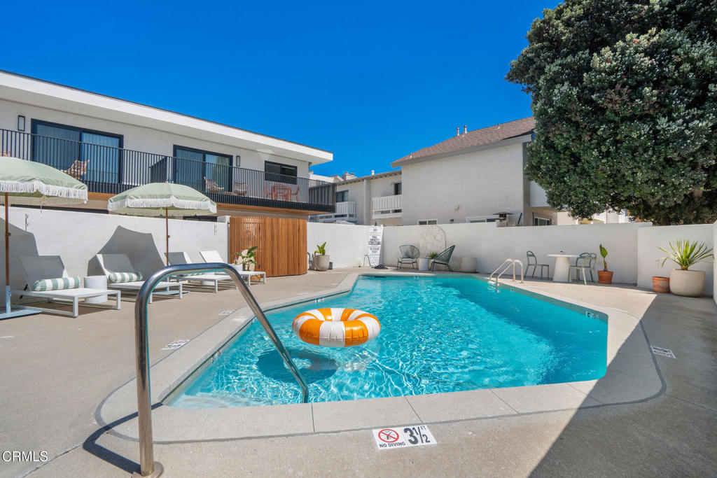 Refined Coastal Living - Mid-Century Charm Meets Modern Luxury, Just One Block from the Beach! Experience a rare opportunity to live full-time in a professionally redesigned mid-century residence just steps from the sand. This fully furnished 1-bedroom, 1-bath unit is part of a quiet, boutique 6-unit building transformed into a stylish coastal retreat. Inside, a bright and open layout features designer-selected furnishings, high-end finishes, and a seamless blend of comfort and style. Large windows fill the space with natural light and ocean breezes, while a private balcony offers a peaceful view of the sparkling pool. The thoughtfully appointed kitchen, spa-inspired bath, in-unit washer and dryer, and air conditioning provide modern convenience, while the building's shared pool invites resort-style relaxation. Located only one block from the beach, this residence is ideal for executive stays, corporate relocation, or anyone seeking a high-end coastal lifestyle. Offered at $3,295 per month with a 12-month lease.