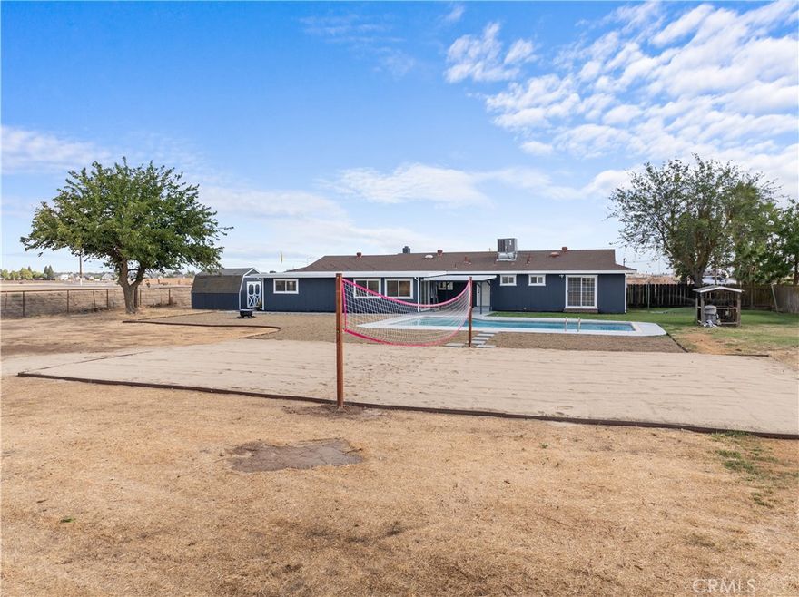 Seize a rare opportunity at 420 East Bellevue Rd—a home where country serenity meets city convenience. This designer-renovated gem welcomes you with fresh modern finishes, luxurious LVP flooring, and a breathtaking kitchen with two-tone cabinetry and Calacatta quartz. Every inch, from the full-wall backsplash to the stylish bathrooms, is crafted to impress.

But the magic doesn’t stop indoors. Step outside to your sprawling acre of possibilities: a newly replastered pool, a sandy volleyball court for endless fun, and a cozy fire pit perfect for evening gatherings. With room for horses, a future ADU, or your own custom shop, this property is a canvas for your dreams.

Best of all, you’re just minutes from UC Merced, Lake Yosemite, and El Capitan High, offering a unique blend of peaceful country living with unbeatable city access. Don’t miss your chance to own this one-of-a-kind retreat that truly offers the best of both worlds!