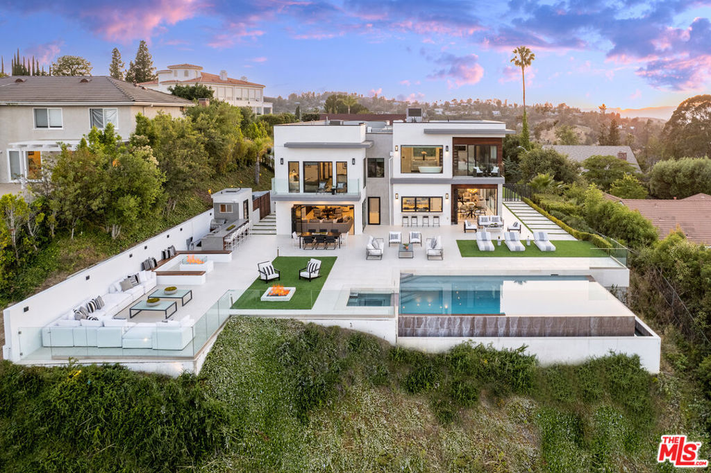 Modern Masterpiece with amazing views and open floor plan with large windows and glass walls to maximize the view. The pocket doors allow for seamless indoor and outdoor flow, creating a sense of spaciousness. Chef's kitchen with high-end appliances and finishes. Porcelain floors, built-in surround sound system.The walls of glass not only offer stunning views but also allow natural light to flood the interior. This truly is a masterpiece of modern architecture, combining sleek lines and contemporary design elements. Great outdoor space for entertaining with infinity pool, perfect for enjoying the breathtaking views, as well as a built-in BBQ area and fire pits for outdoor entertaining.