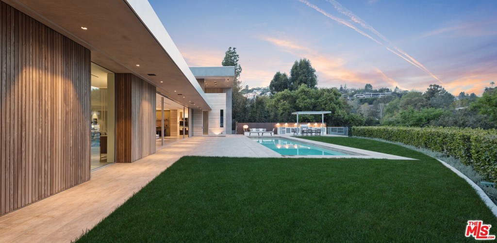 One of the finest examples of Modern architecture in Los Angeles. Clean, contemporary design that integrates timeless Mid-Century elements. Expansive use of luxurious materials throughout. There are walls of retractable glass as well as rooms that can display a substantial art collection. The open and intelligent floor plan captures the quintessential California indoor/outdoor dream. Private backyard with grassy lawn, swimming pool and spa, complete outdoor kitchen, and views of the Bel Air Golf Course. 3 car garage with large, gated motor court for additional parking.Located in prime lower Bel Air on one of the most coveted streets.Once in a decade does a property of this magnitude come to market with years of thoughtful design culminating in a breathtaking masterpiece. Spectacular living in Los Angeles!