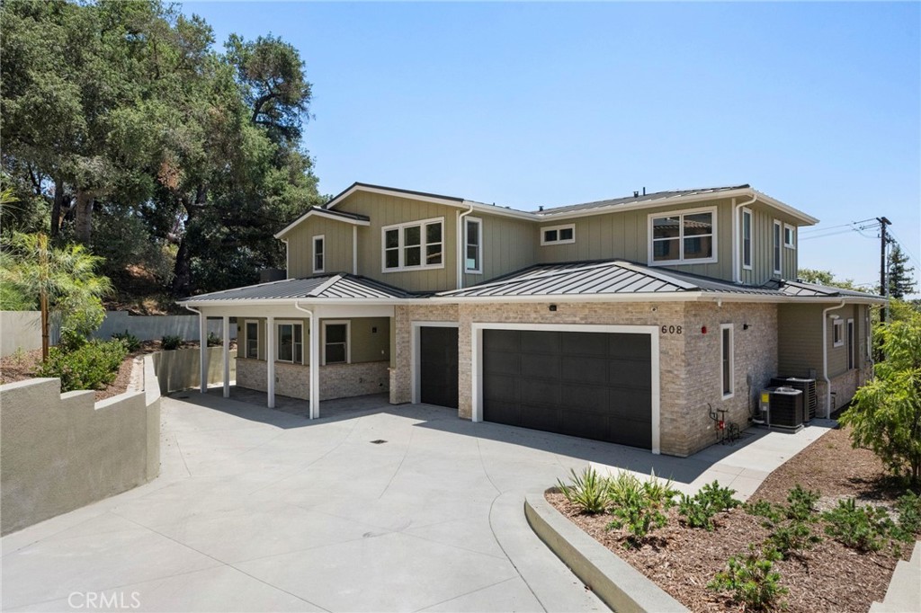 Perched atop Sierra Madre’s coveted north hillside—where new construction hasn’t appeared in decades—this brand-new custom home reimagines the classic contemporary in a crisp palette. The upper level is clad in board-and-batten siding, while a standing-seam metal roof crowns both the welcoming porch and the three-car garage, seamlessly integrated into the façade. Clean-lined, oversized windows and simple trim frame sweeping canyon and city-light vistas beneath the soaring silhouette of Mt. Wilson.
Inside, 3,783 square feet of living space unfolds under vaulted ceilings punctuated by designer light fixtures. Four bedrooms and four-and-a-half baths flow from an open-plan great room into a gourmet kitchen complete with luxurious quartz countertops and abundant natural light. Every surface and sightline has been thoughtfully arranged to enhance the home’s serene surroundings.
Situated at the north end of Baldwin Avenue in one of the West Coast’s most charming, family-friendly towns, you’re just a few minutes’ stroll from downtown Sierra Madre’s boutiques, cafés, and fine dining, and a short drive from Arcadia and the 210 Freeway—putting Pasadena and Downtown L.A. within easy reach. For those seeking a different layout or style, our sister homes at 620 Baldwin Court and 608 Baldwin Court offer their own fresh interpretations of modern farmhouse living.