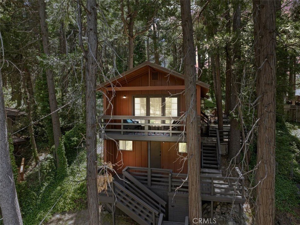 **WELCOME TO THE BIRD HOUSE! Charming Mountain Retreat with Stunning Views in Crestline**
Step into your own serene and cozy escape in the heart of the Crestline mountains. This charming multi-level home offers comfort, character, and breathtaking views—perfect as a full-time residence, vacation getaway, or investment property.
The first level welcomes you with a private bedroom and convenient access to the basement. Upstairs, you'll find a bright and open living space featuring a second bedroom, a beautifully remodeled bathroom, a well-equipped kitchen with newer stainless steel appliances, and a warm, inviting living room centered around a wood-burning stove. Step out onto the balcony and take in the sweeping mountain views—an ideal spot for morning coffee or sunset relaxation.
Set on a large, private lot surrounded by towering trees, this home includes its own walking trails—perfect for enjoying the fresh forest air, peaceful nature strolls, or morning meditation. A spacious deck provides additional space to unwind or entertain while taking in the beauty of the outdoors. Ceiling fans throughout the home provide comfort year-round, and the wood stove adds a cozy touch for crisp mountain evenings.
Located just minutes from Lake Gregory and the heart of town, you’ll enjoy easy access to local shopping, dining, and year-round recreation. From hiking, fishing, swimming, and paddle boarding in the warmer months to skiing and snowboarding in the winter, Crestline is a four-season destination. Don’t miss community favorites like Jubilee Days, the 4th of July parade, and weekly farmers markets with live music.
Whether you're seeking a peaceful retreat or an exciting investment, this mountain gem truly checks all the boxes—including front-row seats to the Fourth of July fireworks over Lake Gregory!