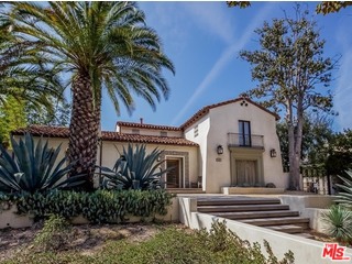 A gated driveway leads to this magnificent Spanish home w/ contemporary accents in Hancock Park. Dramatic 2-story entry foyer w/ sweeping staircase. Hand-carved, walnut parquet flooring is complemented by hand-hewn, distressed ceiling beams. Sub Zero, Wolf and Miele appliances, built-in espresso machine, butler pantry, office nook & a 1,200 bottle temperature controlled wine cellar. Off the kitchen is an elegant formal dining room. Living & family rooms feature retractable doors bringing the outside in & open to a beautiful outdoor seating area w/ fire pit. 2 bd downstairs w/ a full bath between them & 4 bd + a laundry room upstairs. Expansive master suite features a formal entry, large his/hers walk in closets, soaking tub & shower w/ steam room. Backyard offers outdoor kitchen, multiple seating areas, grass lawn, fruit trees, a putting green & a pool w/ new equipment & pebbletec finish. This gorgeous property also includes a beautiful 500 sq ft guest cottage over the garage.