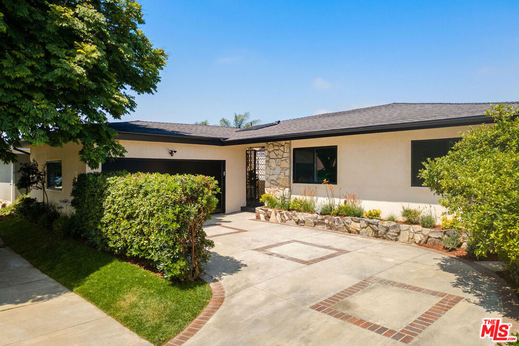 Mid-Century Modern View Home in the Coveted Dons of Baldwin Hills! Perched above the city with sweeping views of Kenneth Hahn Park, this fully reimagined Mid-Century Modern gem blends iconic architectural details with high-end curated finishes. Set on a quiet, elevated street in the desirable Dons of Baldwin Hills, this 3-bedroom, 2.5-bathroom home offers a perfect floor plan, CA indoor/outdoor living, and a flat, grassy yard with a view. Step inside to a dramatic open-concept layout that connects the kitchen, dining, and sunken living room. Anchored by a sleek custom mantle and an original flagstone planter that nods to the home's Mid-Century roots, the living room opens through expansive folding doors, inviting natural light and breezes from the West. The gourmet kitchen is a showstopper featuring elegant countertops with a full-height backsplash, a generous waterfall island perfect for gathering, and bespoke cabinetry accented with Rejuvenation hardware. Just beyond, the freshly landscaped backyard unfolds with a dreamy dining area beneath a pergola--ideal for al fresco meals and entertaining. Retreat to the luxurious primary suite with its large walk-in closet and spa-like ensuite bath. Enjoy terrazzo flooring from Zia Tile, a custom mosaic wall tile, dual vanity, soaking tub, and a separate shower. Primary suite opens to the backyard through a large sliding door for added tranquility. Two additional spacious bedrooms share a beautifully appointed hall bath with Aloft Tiles' terrazzo flooring and complementary wall tile. A stylish powder room at the entry continues the terrazzo theme. Additional highlights include a dedicated laundry and mudroom with access from the attached garage, new plumbing and sewer lines, a 200-amp electrical panel, HVAC system, tankless water heater, and new roof--all completed with permits for peace of mind. Located just minutes from major freeways, commuting to downtown Los Angeles, Culver City, and other key areas is a breeze. Kenneth Hahn State Park and Baldwin Hills Scenic Overlook are just moments away! So close to Jon & Vinny's, Somerville, Hilltop Coffee, and more. A rare offering in one of Baldwin Hills' most beloved enclaves, this stunning home delivers luxury, comfort, and versatility in one of L.A.'s most sought-after neighborhoods! Welcome home!