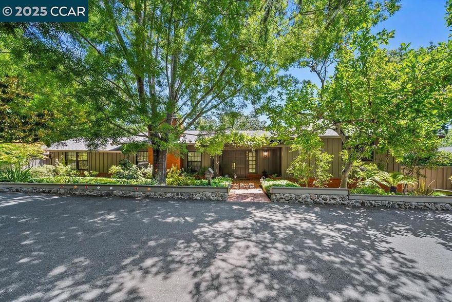 Nestled at the entrance of a peaceful six-home court, 3617 Happy Glen Road welcomes you with timeless curb appeal, lush green landscaping, and a charming boxwood hedge guiding you along a pebbled path to the front porch. Inside, the home features a distinctive stone accent wall and a unique floor plan that lives larger than the records reflect, offering three ensuite bedrooms and spacious common areas designed for comfort and flexibility. The generous kitchen provides an excellent canvas for modern updates, with abundant cabinetry, hardwood floors, and recessed lighting that can be tailored to your personal style. Just beyond, a sunroom addition brimming with character showcases exposed brick walls and a cozy corner fireplace —perfect for year-round enjoyment. With its inviting setting, functional layout, and endless potential, this Happy Valley Glen residence presents a rare opportunity to create your dream home in one of Lafayette’s most sought-after locations.