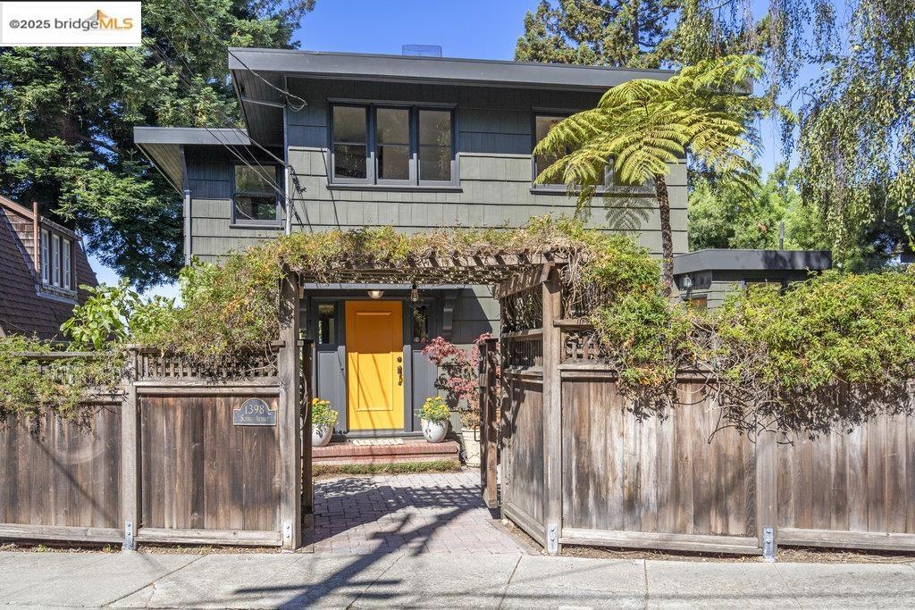 Sited on a lush, serene lot with sparkling Bay and SF views, this multi-faceted property is enriched by architectural details, a private courtyard entry and a coveted Northside location. The warm, inviting brown-shingle home has multiple living spaces and outdoor areas, serving dynamic zones for work, play and R&R. Picture windows and an intimate deck adorn the graceful living and dining rooms, capturing views and vistas from every vantage point. Off the kitchen, an office space with adjacent powder room opens to the dappled courtyard patio garden. Three charming bedrooms on the upper level feature Bay views and green outlooks. Lower levels offer versatile spaces for a variety of interests and lifestyles. An adaptable 1-BR apt/suite for family gatherings, guest/in-law space or robust home office has a large living room with generous deck hovering over the back yard, plus a kitchen & bath. Sunny garden studio (possible ADU?) adjoins the rear patio —imagine garden parties with catering space and a guest bath! Beautiful Mediterranean landscape is punctuated by fruit trees and plenty of space for urban farming and play. Substantial updates make this a move-in-ready home at the epicenter of all the local attractions.