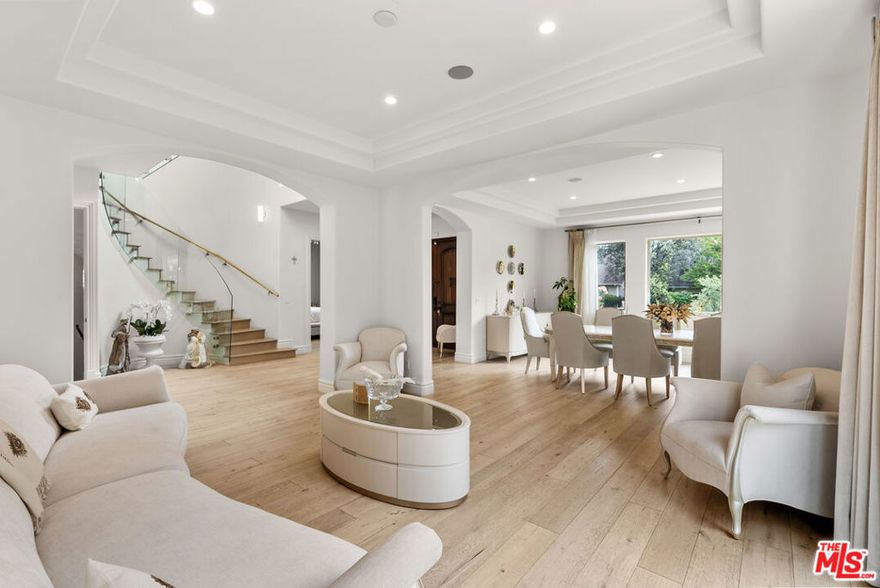 Welcome to this exquisite Mediterranean residence nestled in the coveted Madison Heights neighborhood of Pasadena. Offering 4 bedrooms, 6 bathrooms, and approximately 5,488 square feet of meticulously designed living space, this elegant home blends timeless architectural elements with upscale contemporary finishes. Beyond its stately fade with a clay tile roof and wrought-iron balconies, the home opens to a dramatic double-height foyer with a sweeping staircase framed by glass panels. Rich wood flooring, soaring coffered ceilings, and arched entryways flow seamlessly through formal and casual living spaces, each designed for comfort and style. At the heart of the home lies a gourmet chef's kitchen, complete with custom cabinetry, a substantial center island, high-end appliances, and an open breakfast nook with built-in banquette seating. Adjacent living and dining areas are perfect for hosting, while oversized windows and French doors invite natural light throughout. Retreat to the luxurious primary suite featuring a spa-inspired bathroom with dual vanities, a walk-in glass shower, and a soaking tub surrounded by peaceful garden views. Additional highlights include: En-suite bedrooms with ample closet space, Elegant formal and casual living rooms with fireplaces, Dedicated home gym and custom bar/pantry area, Covered patio and multiple balconies for seamless indoor-outdoor living, Expansive backyard with lush lawn, multiple outbuildings, and gated driveway, Detached garages and abundant guest parking. Set on a beautifully landscaped lot in one of Pasadena's most desirable historic neighborhoods, this turnkey home offers the perfect blend of character, comfort, and luxury living.  Moments from Old Town Pasadena, South Lake Avenue shopping, and top-rated private schools, and with easy access to major freeways (110, 134 and 210), this exceptional residence offers a rare opportunity to own a home of impeccable quality in one of Pasadena's most desirable enclaves. Seller has paid for ADU and pool permits. Should be finalized and available by COE. R.E.S.T. measures main home as 4788 sq ft and separate covered patio/veranda as 665 sq ft and covered patio/game area as 320 sq ft. Information reliable but not guaranteed, buyers or buyer do due diligence to verify all information.