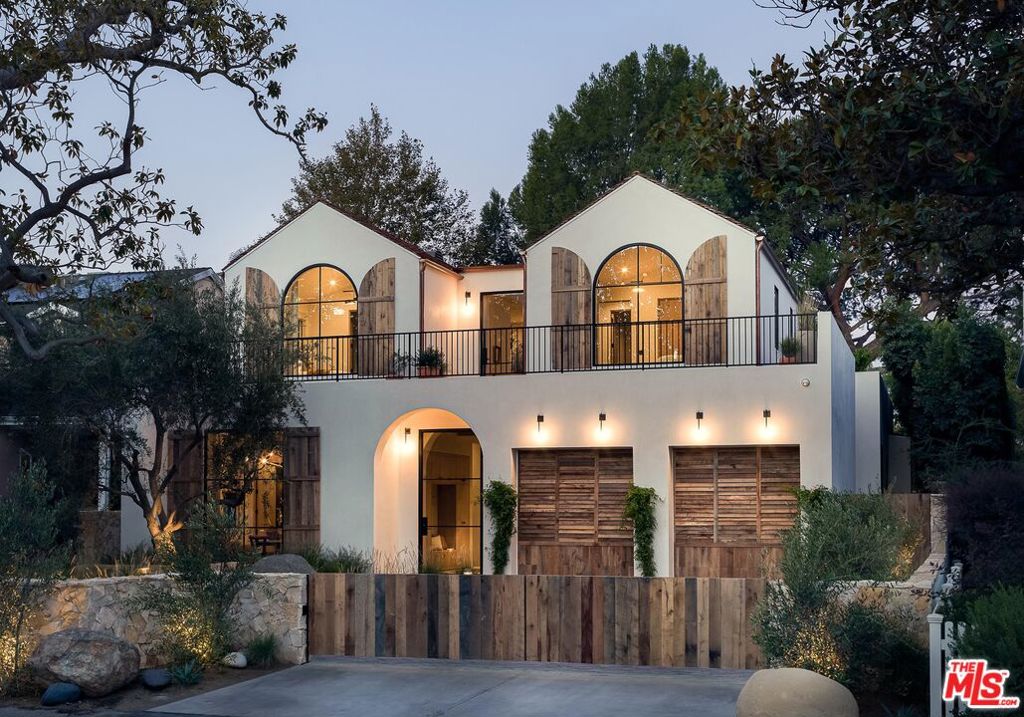 Located on a quiet tree-lined street in the prestigious Longridge Estates sits this newly constructed architectural masterpiece with a fully permitted detached Accessory Dwelling Unit (ADU). Designed with precision and artistry, the residence balances bold form with refined detail. Two striking A-frame volumes rise above the central mass and open to upper-level deck gardens with lush views. Inside, the grand entry hallway showcases sanded limestone floors, oak-encased beams and lighting by Apparatus Studio. A private den and bar with its own courtyard offers the perfect setting for intimate entertaining. The main living, dining and kitchen areas connect seamlessly to the outdoors through expansive Euroline steel doors. Behind the chef's kitchen, a fully equipped prep kitchen enhances functionality for large-scale gatherings. A dramatic staircase with fluted clay walls and custom brass handrails leads to the upper landing, illuminated by a 14-foot steel skylight and framed by garden views. The primary suite exudes understated luxury with a barrel-vaulted clay ceiling, vintage lighting and bespoke woven linen drapery. Dual walk-in closets are anchored by white oak cabinetry, custom hardware, Sub-Zero refrigeration and vintage vanity mirrors. The spa-like primary bath is clad in Calacatta marble with a steel-framed shower that opens to a private garden and outdoor soaking tub accented by Samuel Heath fixtures and Allied Maker lighting. The backyard offers complete privacy with a black-bottom pool, infrared sauna, fire pit lounge and generous space for relaxation and entertainment. The fully integrated ADU (4139 Mary Ellen Ave) provides its own elegance with a kitchen and full bath. Within the highly acclaimed Dixie Canyon Charter School district and moments from the Sportsmen's Lodge and Ventura Boulevard's premier shopping and dining, this exceptional home should not be missed.