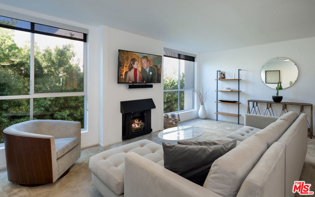 Located in the heart of West Hollywood, this stylish, zen, top floor, corner unit, is very walkable to some of the best restaurants, shopping and nightlife that LA has to offer. This one-bed, one-bath condo boasts over 900sqft of open living space. The expansive, naturally-lit living room features a gas fireplace, dining area and wet bar. The spacious naturally-lit bedroom includes a large walk-in closet. The updated bathroom has a shower, bathtub, dual-sink vanity with lots of storage space, and in-unit laundry. The spacious kitchen also boasts tons of storage space, and whirlpool appliances. This pet-friendly building has two laundry rooms on every floor, a large heated pool in the central courtyard, covered gated parking, and is located on a charming tree-lined street.
