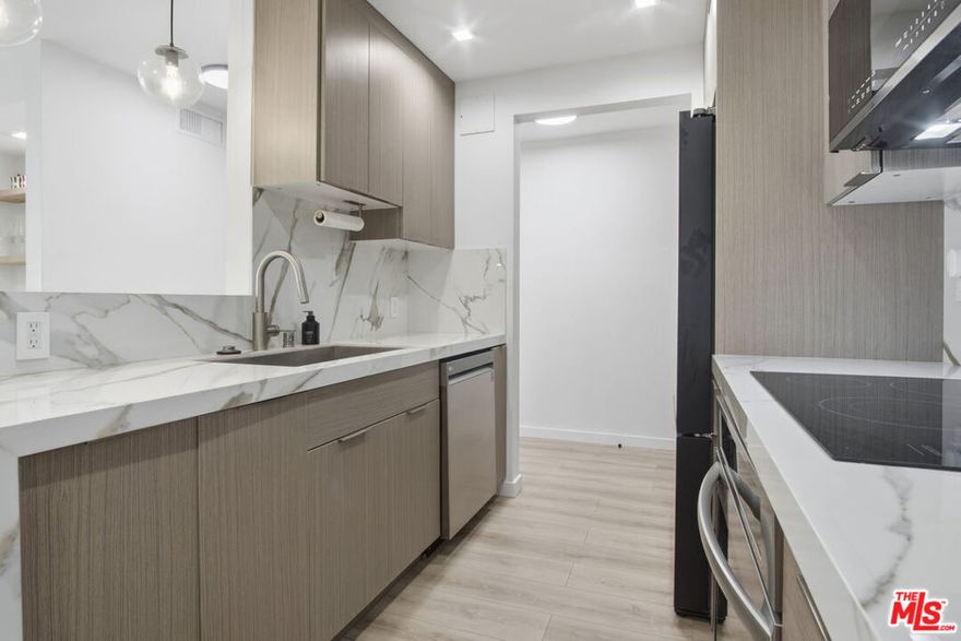 Discover elevated metropolitan living in this impeccably updated 1-bedroom, 1-bath residence, perfectly positioned on one of West Hollywood's most desirable, tree-lined streets. Blending modern sophistication with effortless comfort, this second-floor condo offers a serene retreat just moments from the city's best shopping, dining, and nightlife. Step inside to a light-filled open layout, where a spacious living room with a chic fireplace flows seamlessly to a private, covered balcony overlooking the lush courtyard and sparkling pool, ideal for morning coffee or evening unwinding. Floor-to-ceiling glass sliders invite indoor-outdoor living at its finest. The beautifully renovated kitchen features quartz countertops, sleek cabinetry, and a generous dining area perfect for hosting. The serene bedroom includes an expansive walk-in closet and an east-facing window that welcomes soft, natural light. A spa-inspired bathroom showcases a quartz vanity, floating cabinetry, and a designer shower with a rainfall shower head. Additional highlights include recessed lighting throughout, central AC and heat, and ample storage. Residents enjoy coveted building amenities: a resort-style pool, fitness center, controlled security access, and one assigned parking space in the gated garage. Cable, WiFi, water, trash, and HOA fees are all included, an exceptional value in this premier location. Nestled between Santa Monica Blvd. and Melrose Ave., and just moments from Kings Road Park, Erewhon, Gelson's, and countless iconic L.A. destinations, this unit offers both luxury and lifestyle in equal measure. Available furnished for $3,750 for a truly turnkey, elevated living experience.