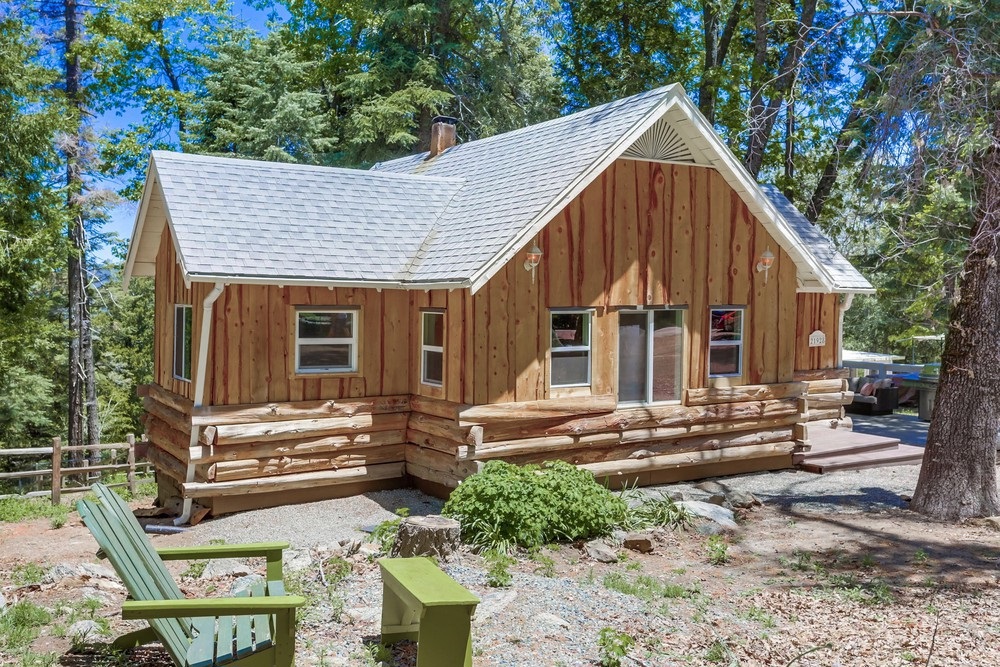 Enchanting cabin nestled on beautifully-treed, level one-half acre. Call listing agent for more details: 619.403.4222. Arrive via the pull-thru driveway (40' RVs & trailers no problem), with access virtually regardless of weather. Take a moment to contemplate your 400sf outdoor living space (Trex deck) before touring the new kitchen (white shaker cabinets/European soft-close hinges, Quartz counters), original wood floors, professionally refinished, vaulted ceilings, double-pane windows & so much more. Dual-fuel stove - electric oven for precise baking and propane stovetop for cooking. Vaulted ceilings in the master bedroom and kitchen. All new electrical wiring and outlets (GFCI where appropriate). New kitchen with deep undermount, stainless steel sink, with large pull-out faucet. Dual-pane, insulated, high-energy-efficient windows throughout. Large one-half acre lot, full road frontage (plowed in winter), RV/Trailer parking, plenty of space for ADU up to 1,200 sf. SD County waiving fees thru 2023. Remember, the County doesn't specify which home you live in. You can build or bring a home up to 1,200 sf onto this large lot, live in this one, and use the existing, charming home as a vacation rental or??? This is both a special and unique property in that you have full and complete access to the property year-round. As you probably know, homes on dirt roads, or even with slight inclines/declines, particularly when wet or snowy, are not always passable, so you find yourself parking away from your home (sometimes ay great distances) and trekking in and out every time you leave home. Crestline is plowed by the County, and this pull-through, level driveway feels heaven sent.. Neighborhoods: North Crestline Equipment: Dryer, Range/Oven, Washer Other Fees: 0 Sewer: Septic Installed Topography: LL,GSL