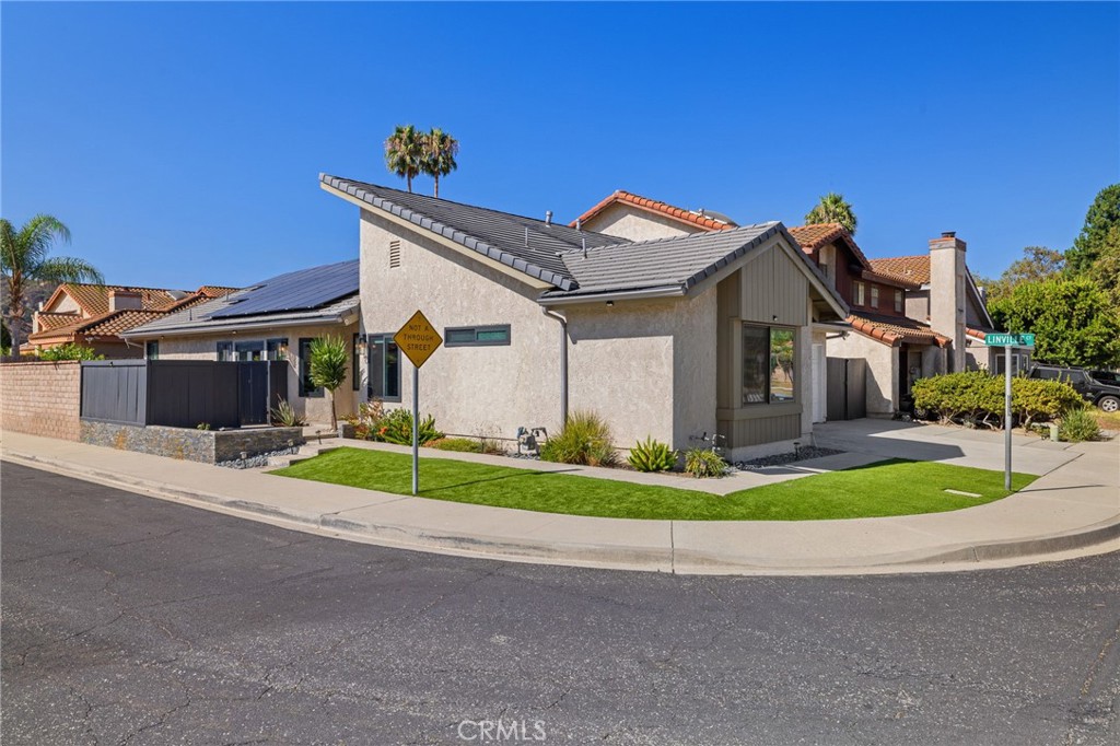 From the moment you arrive, you'll be greeted by stunning curb appeal featuring a stacked stone planter, garden lighting, low-maintenance faux turf, fresh landscaping, and the signature Dracena plant. The angled roofline nods to mid-century modern design, complemented by stylish new gray cement roof tiles and fully owned solar panels.
Step inside the light-filled foyer and take in the soaring ceilings and open living space, enhanced by new recessed lighting, wide-plank gray laminate flooring, new baseboards, and custom French doors that open to a charming patio—perfect for morning coffee. The spacious backyard features a lemon tree, a tranquil sitting area, turf for lounging and playing and space for a raised garden or potential small pool.
At the heart of the home is an updated atrium with a custom skylight and a striking waterfall-style tile wall—creating a peaceful focal point for the dining room. The generous kitchen includes a second skylight, white cabinetry, glass tile backsplash, stainless steel appliances, pendant lighting, a gas range, built-in microwave, and dishwasher.
Retreat to the luxurious primary suite, complete with a cozy fireplace, private patio access, a sitting area, and a walk-in closet with 10-foot custom built-ins. The spa-like en-suite bathroom showcases dual sinks, marble counters, dramatic tile accents, a freestanding tub, and a separate shower. Two additional bedrooms are located on the opposite side of the home and share an upgraded modern bathroom.
Smart upgrades include designer interior paint, new windows, Nest thermostat, new electrical panel, and a 240V outlet for EV charging. The attached 2-car garage offers direct home access, laundry hookups, and ample overhead storage.
Located on a peaceful cul-de-sac with larger lots, you're just steps from College View Park with its playground, enclosed dog park, and picnic area. Close to Starbucks, local dining, Moorpark College, the Teaching Zoo, and upcoming amphitheater plans, this home combines tranquility with convenience—offering an ideal lifestyle just a short drive from Los Angeles.
Move in before the holidays and enjoy a turnkey home in a vibrant, welcoming neighborhood!