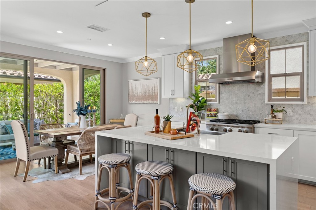 Located in the heart of Eastwood Village, this spectacular Petaluma home eagerly awaits you. A masterful open floor plan concept is brought to life with amazing designer upgrades throughout, creating a seamless blend of elegance and functionality. The chef’s kitchen is a true centerpiece, featuring Thermofoil Shaker cabinets extending to the ceiling, a stunning custom waterfall island with pendant lights and grey cabinetry for added storage, and quartz countertops complemented by a full marble backsplash. An upgraded top-of-the-line stainless steel appliance package completes this culinary space. Retreat upstairs to a luxurious primary suite showcasing an ensuite master bath with dual sink vanities, quartz countertops, and a frameless glass shower with upgraded tile walls and flooring. Laminate wood flows across the first floor, while premium carpet with an extra-thick mold-proof underlayer and upgraded tile in all bathrooms and the laundry room provide comfort and durability. Every detail has been thoughtfully designed: custom paint throughout, double wall insulation for efficiency and noise reduction, Nest smart thermostats, white window shutters, recessed lighting in all bedrooms and bathrooms, and upgraded stainless steel cabinet handles. The backyard is perfect for entertaining with tile and artificial turf flooring, trees with a drip system managed by a Rachio smart controller, and LED accent and overhead lighting. Even the garage impresses with epoxy floors, ceiling-mounted storage, a smart opener, and a Tesla charger. Close proximity to resort style amenities including Jr. size Olympic pools, parks, shopping plazas, and Irvine Unified Distinguished schools. This remarkable Petaluma residence captures the best of Eastwood Village living—modern, refined, and truly turnkey.