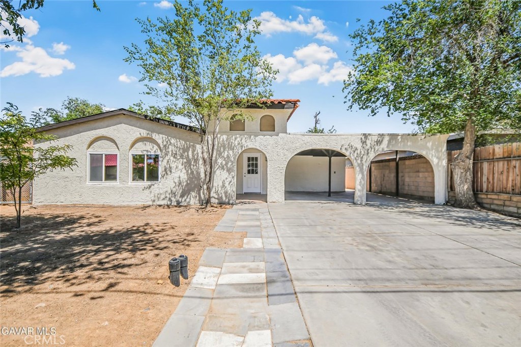 This fully renovated and move-in ready home is a standout opportunity you won't want to miss! Right when you drive up, you'll be impressed by the beautiful curb appeal that sets the tone for what's inside. Freshly painted inside and out, this property shines with modern charm and thoughtful updates throughout. Step into the completely remodeled kitchen featuring brand new cabinets, sleek quartz countertops, stainless steel appliances, and a deep stainless steel sink—everything is brand new, including the plumbing fixtures and lighting. The home boasts brand new plank flooring throughout, adding warmth and consistency to the two spacious living areas and dedicated dining area. Both bathrooms have been fully redone and now include new vanities, sinks, toilets, and faucets. The full bath features a beautiful custom tile surround in the tub/shower combo, along with all new plumbing fixtures. Every light fixture in the home has been updated for a modern finish, and the laundry area is conveniently located inside. Outside, the fully fenced backyard is enclosed with a block wall for privacy, and includes a storage shed for added functionality. A 2-car carport offers covered parking, and solar panels on the roof provide energy efficiency. Located near schools, shopping, and restaurants, this is a rare offering that combines comfort, value, location, and style—come see this incredible home before it's gone!
