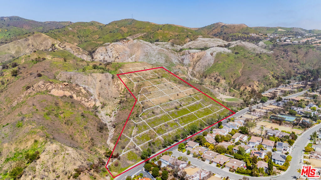 Incredible value in the Palisades Highlands! This expansive 423,653 sq ft lot (nearly 10 acres) has never been developed, offering a rare opportunity to design and build a custom estate or possibly multiple structures in one of Los Angeles' most sought-after neighborhoods. Located on Michael Lane, the property features ocean and mountain views and is priced at just $6 per square foot, making it an exceptional opportunity in the Palisades. Surrounded by nature, the setting offers a sense of peaceful serenity while still being just minutes from scenic hiking trails, the beach, Palisades Village, and top-rated schools. Whether you're creating a private retreat, family compound, or investment project, this blank canvas offers remarkable potential in a tranquil hillside location.