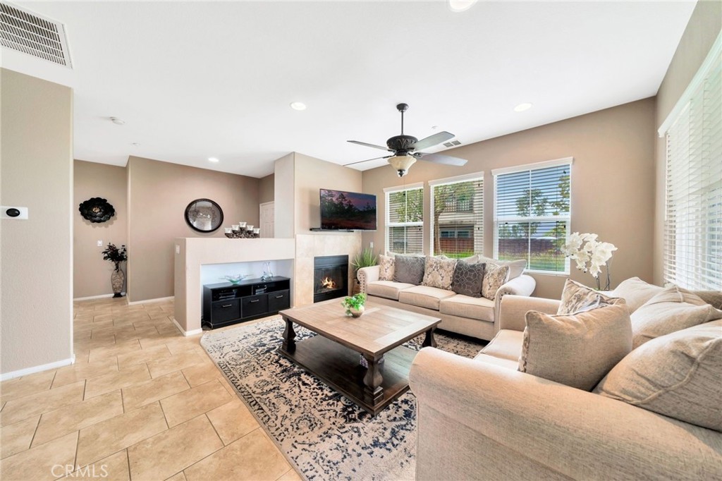 Welcome to one of the most desirable homes in the sought-after Vista Del Lago community of Lake Elsinore! This stunning 3-bedroom, 2.5-bathroom end-unit townhome offers 1,527 sq. ft. of thoughtfully designed living space, a two-car garage with driveway parking for two additional vehicles, and no neighbors on one side for enhanced privacy!
The home boasts spectacular lake, mountain, and city-light views from both the backyard patio and the primary suite’s private balcony—perfect for watching sunsets or fireworks from Lake Elsinore Storm Stadium. Inside, the open-concept floor plan is filled with natural light, featuring a spacious living room with abundant windows, a formal dining area for gatherings, and a bright kitchen with rich cabinetry, granite countertops, stainless steel appliances, and a cozy breakfast nook. The sliding glass door seamlessly connects the indoor spaces to the spacious patio, ideal for entertaining or those relaxing evenings.
The primary suite is a private retreat with double-door entry, a large walk-in closet, dual sinks, a tub-shower combo, and its own balcony with panoramic views. Two additional bedrooms upstairs are generous in size and share a well-appointed hall bath. A huge inside laundry area offers direct garage access for convenience.
Vista Del Lago provides resort-style amenities, including a gated pool and spa, picnic areas, playground, and scenic walking paths. Its prime location offers quick access to the 15 Freeway for an easy commute to San Diego or Orange County, while shopping, dining, and Lake Elsinore’s charming downtown are just minutes away.
With its premium location, upgrades, and unbeatable views, this home is truly one of the best in the community!