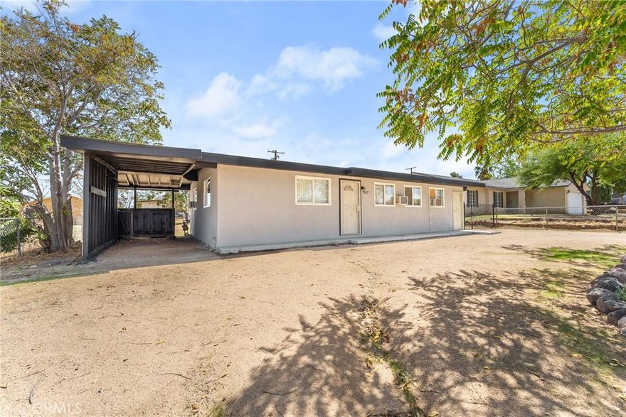 Welcome to this beautifully remodeled 3-bedroom, 2-bathroom home situated on a spacious 8,100 sq. ft. flat and usable lot in the heart of Yucca Valley. The home features timeless white cabinets with granite countertops, durable tile and luxury vinyl plank flooring, and two separate driveways for added convenience. The primary bedroom offers a private entrance, making it ideal for guests or a potential rental opportunity. Perfectly located just 27 miles from downtown Palm Springs, 40 miles from Redlands, and 121 miles from Los Angeles, this property is the ultimate desert getaway. Within walking distance to shopping and only minutes from Joshua Tree National Park, you’ll enjoy breathtaking desert landscapes, endless hiking, world-class stargazing, and the serene beauty of wide-open skies.