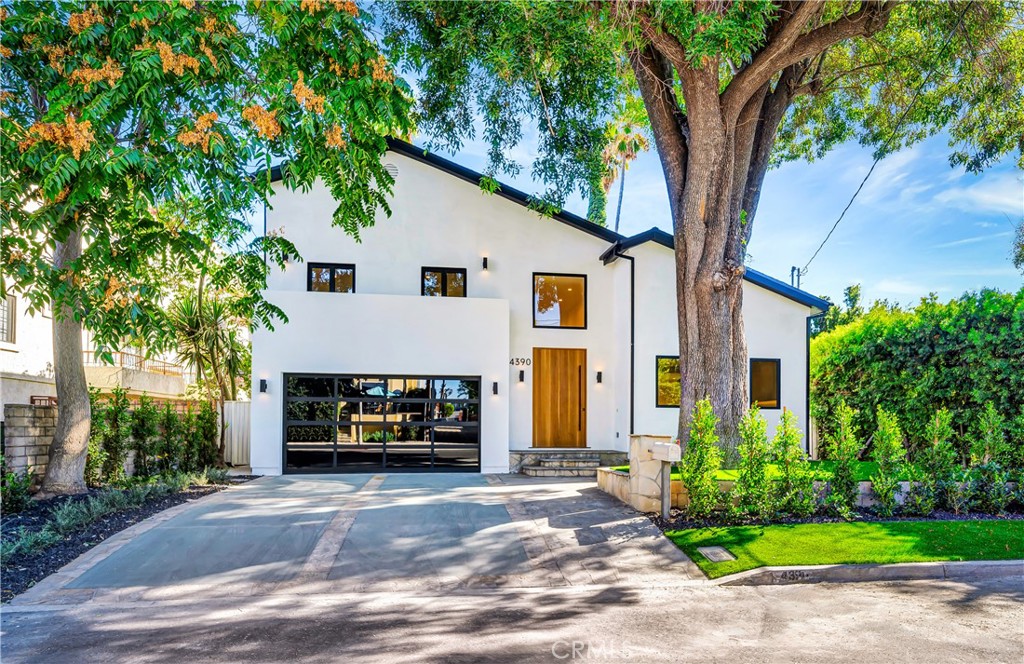 Located in the coveted Colfax Meadows neighborhood of Studio City, this beautifully remodeled home offers the perfect blend of sophistication, comfort, and functionality. With 4 bedrooms, 4 bathrooms, and a detached ADU, this turnkey residence is ideal for today’s lifestyle.
Behind a canopy of mature trees and clean contemporary lines, you’ll find a bright and inviting floor plan filled with natural light, high ceilings, and seamless indoor outdoor flow. The open concept living and dining areas are enhanced by wide plank wood flooring and designer finishes throughout.
At the heart of the home is a chef’s dream kitchen featuring sleek custom cabinetry, premium stainless steel appliances, an oversized island with waterfall quartz countertops, and striking pendant lighting. Large picture windows bring in views of the lush surroundings, creating a serene and inspiring space to cook and gather. The spacious primary suite offers a private retreat with a spa-like bathroom, while three additional bedrooms and baths are thoughtfully designed for flexibility, perfect for family, guests, or a home office. Enjoy living just minutes from Tujunga Village, award-winning schools including Carpenter Charter, popular dining, boutiques, and major studios, all in one of the most desirable pockets of Studio City.