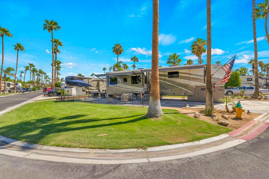 Experience the epitome of the Palm Springs lifestyle with this truly amazing, turn-key RV package. This expanded corner lot is a prime find, situated near the front of the resort for effortless entry and exit. The property is a lush and private sanctuary, with gorgeous greenbelt on both the side and behind, creating a tranquil setting. Enjoy stunning, unobstructed mountain views from the comfort of your patio.The package includes a luxurious 2021 DRV Mobile Suites Santa Fe, an RV known for its high-end finishes and spacious design. This offering comes complete with everything you need for immediate enjoyment: steps, a storage shed, a BBQ grill, washer/dryer, dog fencing, comfortable patio furniture, and a western golf cart for easy resort navigation. Simply bring your clothes and a toothbrush to start living your desert dream.Outdoor Resorts Palm Springs is a Five Star RV Resort Community combining luxury with affordability. It is a guard gated resort that sits on 137 beautifully landscaped acres with 27 holes of executive golf, 10 tennis courts, 13 pickleball courts, 8 swimming pools, a fully equipped fitness center, espresso bar, sports bar, beauty salon/barber shop, full-service restaurant, convenience store, 2 club houses, activities, special events and so much more.