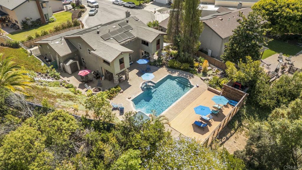 It seems the world is obsessed with houses. We are enamored with the imagery and imagination of endless properties as we scroll. Once in a while, we see a house and almost all of us will have the same reaction: Hmmmm, What is THIS? We believe 2983 Murat Street in North Clairemont will garner that reaction due to its absolute uniqueness, space and charm. One of the largest lots on the street at over 13,000 square feet, this is either an executive's entertainment home, a family's home complete with swimming lessons, or a space to luxuriate in quietly for one or two "we keep to ourselves" types. Located at the end of the cul-de-sac, this four bedrooms + bonus room, three full bath home is offered for sale. No HOA. Main floor has a full bedroom and ensuite bath with shower plus a convenient door to the backyard. Craftsman style throughout, the showcase living room has gorgeous floors, recessed lighting and a wood burning fireplace. The open chef's kitchen with a gas range and modern appliances shares conversation space with both the media room and dining area. And with a big kitchen window looking out over that glorious backyard! Speaking of which, this is perhaps the last backyard you'll need in this lifetime. Grand pool, built-in seating, koi pond, waterfall, secret meditation garden (behind the pool wood fence -- take a peek!), and fire pit. This entire space feels like you're somewhere else and not fairly close to a Costco run or doing city errands. Solar -- to be paid off at closing for the buyer. And a refrigerated wine room in the garage. Upstairs are two secondary bedrooms: one with a balcony over the backyard. The office on the opposite side has access to the sauna room, which also looks out over the backyard. The upstairs has two full baths. The primary bedroom is open in concept and shares space with that office. Moderate reconfigurations can add a door to the primary bedroom. We feel the price is fair for this tremendous offering. While the overall look of the property says "entertainment" and perhaps even parties, we believe there is a quiet whisper throughout the grounds that may get you to take up reading again. With paper books, lounging by your pool. Make time to tour the property with all decision-makers present and consider an offer on this home.