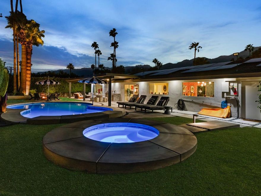 Bold design elements and thoughtful updates define this vibrant Palm Springs retreat where sophistication meets comfort. Behind a new privacy wall and motorized gate, the residence reveals multiple entertaining areas, abundant natural light, and an effortless indoor-outdoor connection that also captures beautiful mountain views. The open layout links the living room to an expansive kitchen with quartz surfaces, a massive island, and stainless-steel appliances--an inviting space for cooking, dining, and gathering. Modern improvements include new HVAC systems, paid solar system with additional battery storage, an EV charger, and upgraded pool equipment with heater for energy-efficient living. The resort-style backyard has been redesigned with an added spa, a relocated fire pit, a barbecue station, and a huge wide pergola covering the patio with integrated lighting for relaxing or hosting gatherings. Three well-sized bedrooms, including a serene primary suite with stylish touches, provide privacy and comfort. Additional upgrades such as newer patio doors in the dining area, newer patio doors in all three bedrooms, epoxy-finished garage flooring, upgraded exterior lighting, and professionally designed desert landscaping enhance the home's aesthetic, comfort, and long-term value. Furnishings are negotiable outside escrow per the Seller Inventory List. The residence has a very successful STR track record.