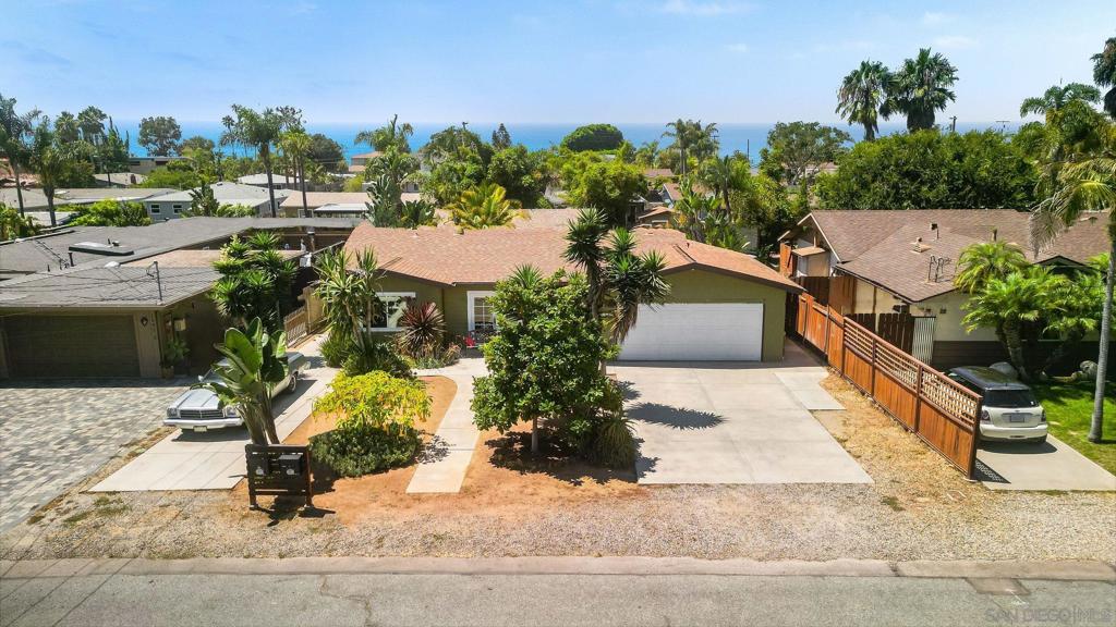 Charming Beachside Oasis with Spacious ADU Welcome to 1080 Aloha Drive, a delightful beach home embodying the perfect blend of modern upgrades and coastal charm. Situated on a generous lot, this property boasts a stylish main house and a fully-permitted detached ADU, offering endless possibilities for multi-generational living or rental income. Main House – 1,334 Sqft Step inside this beautifully updated residence where comfort meets functionality. The kitchen, remodeled in 2009, features custom cherry cabinets, granite countertops with a convenient breakfast bar, sleek stainless steel appliances, and a stunning slate backsplash. Culinary enthusiasts will appreciate the gas cooktop and electric convection oven, all highlighted by recessed and bar lighting. French doors in the kitchen and living room open up to the lush outdoor space, seamlessly blending indoor and outdoor living. Living & Bedrooms: Enjoy the warmth of bamboo flooring throughout the living room, hallway, and bedrooms, creating an inviting and cohesive atmosphere. Primary Suite: The primary bedroom and bathroom underwent a meticulous addition and remodel in 2010, complete with permits. Appreciate the elegant bamboo floors, French doors with reclaimed wood trim, and a luxurious bath featuring a slate and river rock standing shower. Additional Features: The half bath was updated in 2015 with slate countertops and the hall bath received a makeover in 2020, featuring ceramic tiles and a modern vanity. Outdoor Paradise The exterior of the home is a dream come true for beach lovers and gardening enthusiasts alike. A mosaic and slate outdoor shower with a wooden surfboard rack caters to the surfer's lifestyle. The low-water, drought-friendly front and backyards are adorned with decomposed granite, Baja Cresta rock garden areas, and a stunning array of succulents, yuccas, and tropical plants. The backyard also offers a grassy area, fire pit, additional patio, and four raised garden beds, all set against a backdrop of tropical landscaping, creating a serene retreat. Just 1.5 miles to Swamis Beach, walkable to Ocean Knoll Elementary, Oak Crest Middle and San Dieguito Academy. Versatile Shed: Discover a 10x12 Hardiplank shed, perfect for a she-shed, yoga room, or any creative space you envision. Detached ADU – 492Sqft The detached 1-bedroom, 1-bathroom ADU offers privacy and style, complete with its own fenced yard and parking for two small tandem cars. Interior: Discover life-proof vinyl plank flooring, a subway tile shower, mosaic backsplash, stainless steel appliances, and quartz countertops. The ADU's farmhouse sink and breakfast bar add a touch of charm. Exterior: Enjoy a low-water backyard with decomposed granite and a separate storage shed for added convenience. Other notable features of the property include tankless water heaters in both units, ceiling fans throughout, and a 200-amp panel on the main home installed during the ADU's construction. The main house also includes a laundry room addition off the garage and an ADU stackable unit in an exterior cabinet. 1080 Aloha Drive is more than just a home; it’s a lifestyle. Embrace the tranquility of coastal living with modern amenities and plenty of space for all your needs. Don't miss your chance to own this exceptional property in a prime location.