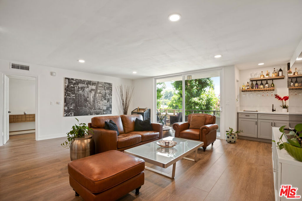 Welcome to this beautifully remodeled two bedroom, two bathroom condo in the heart of Encino. Just steps away from the legendary Amestoy Estates, you can enjoy picturesque walks in one of the most sought after neighborhoods in the area. The split floor plan offers ultimate privacy for both bedrooms, while large windows fill the home with an abundance of natural light. The spacious open concept layout seamlessly connects the kitchen to the living room, creating an inviting space for both daily living and entertaining. Step out onto your private balcony, the perfect spot to enjoy your morning coffee or unwind with an evening glass of wine. The kitchen is a showpiece, featuring shaker style cabinetry, sleek quartz countertops, new black stainless steel appliances, a built in workspace, and a beautiful wet bar. New waterproof flooring runs throughout, complemented by recessed lighting in every room. Both bathrooms have been tastefully updated with light toned designer tiles. Recent upgrades include brand new windows and a sliding door, a new AC unit, a new side by side washer and dryer, and the peace of mind of a brand new roof on the building with the special assessment already paid in full. With only one shared wall, this unit offers exceptional peace and quiet. You will also enjoy two dedicated parking spaces with an overhead storage unit in the secured garage. The controlled access building features a formal lobby, elevator, common area laundry, pool, and BBQ area. HOA dues include water and trash. Perfectly located near multiple parks, Equinox, popular eateries, boutiques, and the vibrant Encino Commons along Ventura Boulevard, with easy access to the 101 and 405 freeways and the Metro Busway. This stunning condo is move in ready and offers the perfect combination of style, comfort, and convenience.