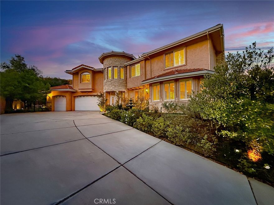 Welcome to the exclusive gated enclave of Lynn Oaks Estates.  This stunning residence is perched atop a long private driveway and offers breathtaking surroundings on approximately 1.5 acres. This one-of-a-kind property includes a working beehive for fresh honey, a charming chicken coop, and potential building opportunity, with the possibility of a separate access driveway via a neighboring easement with breathtaking 360-degree view—enjoy sunrise to sunset views of the surrounding mountains, rolling hills, and city lights. Behind elegant double entry doors adorned with leaded glass insets, you're greeted by a showstopping circular wrought-iron staircase, setting the tone for the sophistication throughout. The formal living room boasts dramatic cathedral ceilings, a custom fireplace, and ornate iron-accented windows that flood the space with natural light. An arched passageway leads to the formal dining room, perfect for hosting elegant dinners. Adjacent, the butler’s pantry flows seamlessly into the heart of the home—an expansive gourmet kitchen equipped with stainless steel appliances, a large walk-in pantry, and a generous center island, all open to a spacious dining area and inviting family room complete with fireplace, wet bar, and plantation shutters. Downstairs also includes a versatile office/gym, a guest bedroom, and two baths, offering comfort and functionality for family and guests. Upstairs, the massive primary suite serves as a private sanctuary featuring a balcony with a view of the backyard, an ensuite bath with dual vanities, a soaking tub overlooking the backyard, a separate shower, and a private water closet. Additional bedrooms include one with a private ensuite and two sharing a Jack-and-Jill bath, all designed with comfort and style in mind.

Step outside to a newly sodded backyard, perfect for entertaining with an elevated platform ideal for al fresco dining. Venture up the tiered slope via a scenic staircase that leads to a breathtaking 360-degree vista—enjoy sunrise to sunset views of the surrounding mountains, rolling hills, and sparkling city lights. Don’t miss your chance to own a truly unique property offering land, and limitless lifestyle potential in one of the area’s most desirable gated communities.