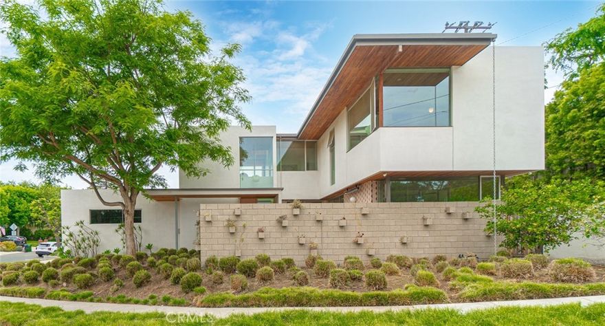 Welcome to The Courtyard House!  Recipient of the 2019 AIA LBSB Honor Award, this exceptional home was designed by the renowned Ras-A-Studio, an architectural firm known for creating spaces that elevate quality of living while making a positive impact on the environment and the community.



Nestled on a corner lot in the desirable Mira Costa neighborhood, The Courtyard House is just steps away from the award-winning Mira Costa High School and Pennekamp Elementary, and less than a mile from the beach.



Designed for both beauty and privacy, the home is thoughtfully enclosed by a concrete masonry wall that integrates built-in planters filled with drought-tolerant plants.  The courtyard, pool, and patio are shielded from public view, ensuring a peaceful retreat. For a touch of warmth and color, the home showcases Western red cedar ceilings and a striking pink front door and patio wall.



Inside, the spacious open floor plan centers around a kitchen and dining area.  Floor-to-ceiling retractable glass pocket doors blur the lines between interior and outdoor living, leading to the backyard where an innovative "endless pool" awaits; perfect for swimming, fitness, training, therapy or leisurely relaxation.  After a swim, cozy up by the built-in, gas powered fire pit or entertain with ease in the spacious courtyard at the outdoor built-in BBQ grill.  A versatile bonus room off the dining area serves as an ideal office, entertainment space or fifth bedroom.  



The home offers four bedrooms in total:  three upstairs, one downstairs.  The primary ensuite overlooks a tranquil park view.  The luxurious primary bath features heated floors.  The remaining upstairs bedrooms have solar-scooped window frames that control sunlight. Upstairs, a large built-in office nook offers a quiet, efficient workspace.  A mudroom leads to the oversized garage, which accommodates two large vehicles and is equipped with an EV charging port.



Designed with California modern informality in mind, the home is also eco-conscious, fully solar-powered, and harmoniously integrated with its surroundings.
