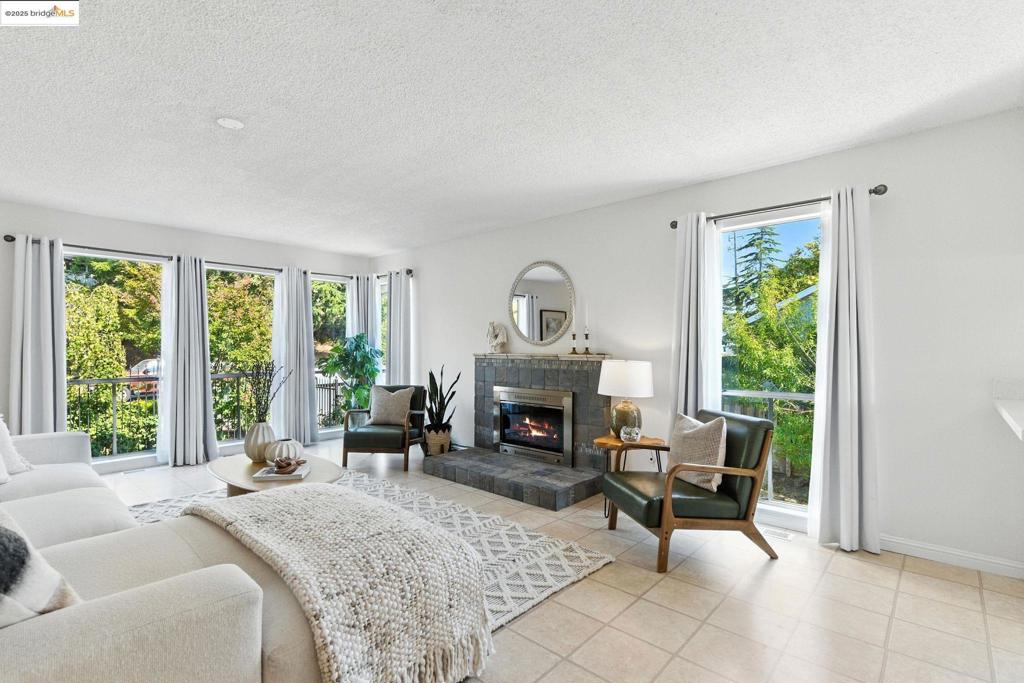 Calling all gardeners! Set at the end of a peaceful cul-de-sac, this 3-bedroom, 2-bath single-level home sits on a generous 9,000 sq ft lot (per public record) with fruit trees, mature landscaping, and a large, modern greenhouse ready for year-round growing. The spacious layout offers all bedrooms and baths on one level, plus an oversized living room with a stone-tiled wood-burning fireplace. The dining area flows into an updated kitchen with quartz counters, new cabinets (2024), and fixtures. Bathrooms are refreshed; lighting is new in the dining room, entryway, and bathrooms (2025). Love dogs? Full-perimeter fencing means Fido can run free. Out back: cherry, plum, pear, Meyer lemon, pomegranate, and walnut trees. Up front: lush colorful plantings for privacy, including roses, jasmine, irises, lilies, birch trees, and more. Below, an oversized garage with abundant storage, interior stair access, and side entry—perfect for parking, workshop space, or potential ADU*. Close to I-80, shopping, restaurants, East Bay Regional parks, the Bay Trail, and San Pablo Reservoir. Walk to the local middle school**. Room to make it your own, indoors and out.